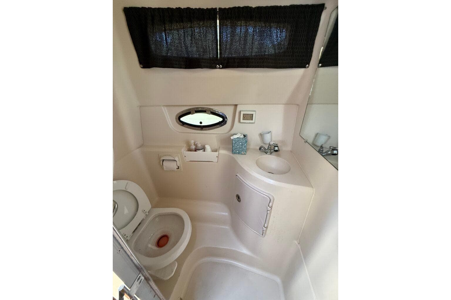 Bathroom interior of 2007 Regal 2565 Window Express boat, featuring toilet and sink.