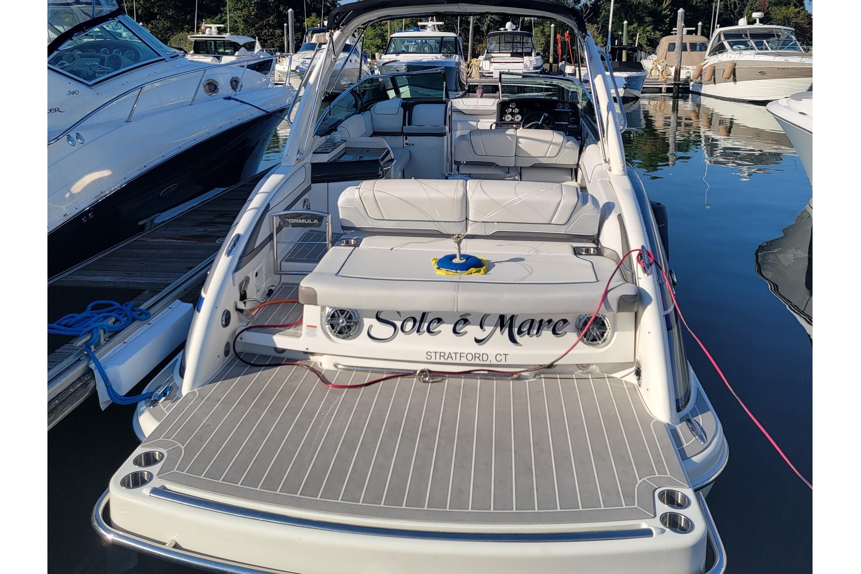 2016 Formula 310 Bowrider docked, featuring spacious seating and sleek design.
