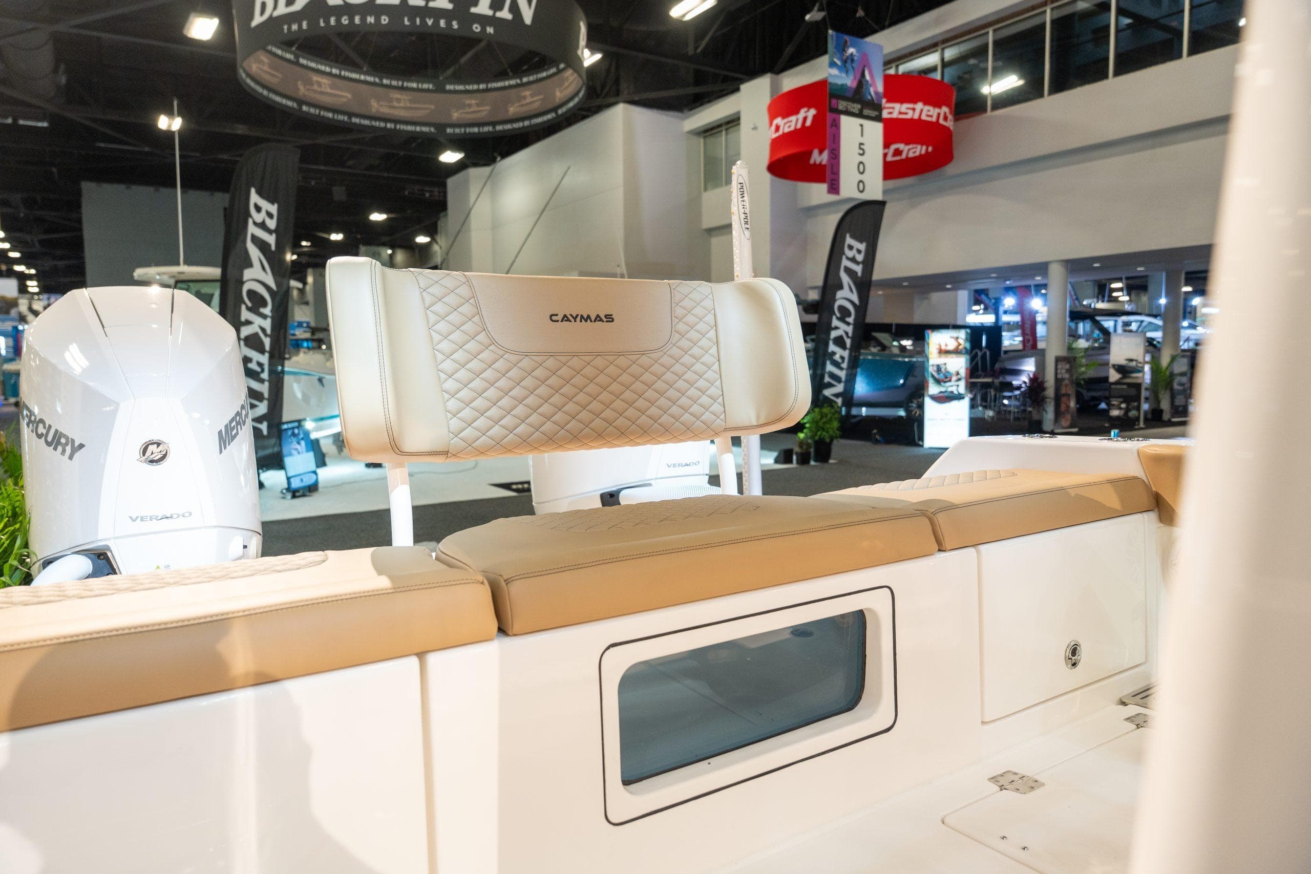 Caymas 29 CT 2027 boat with Mercury engines at a trade show.
