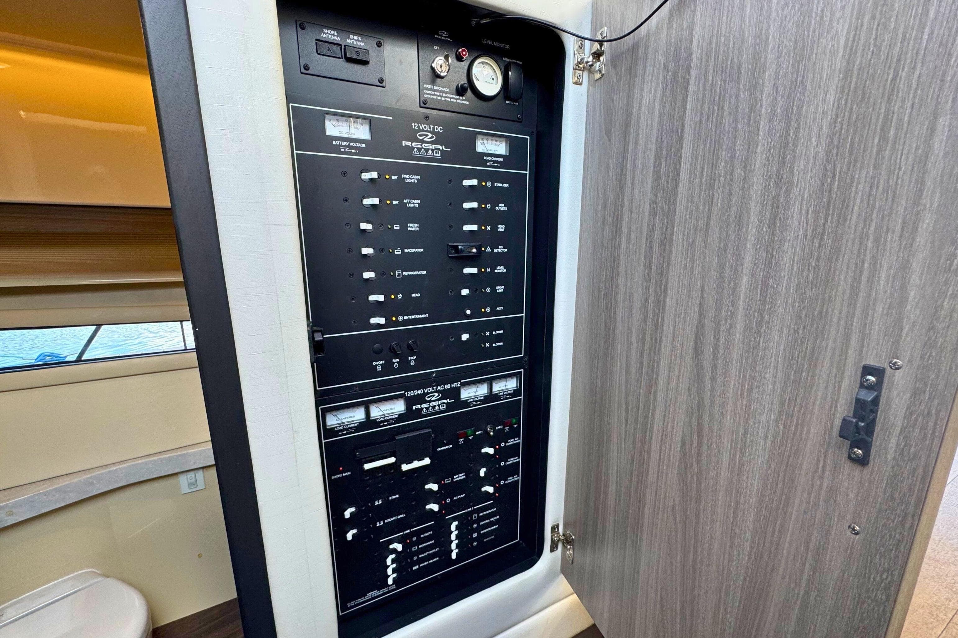Electrical panel inside 2021 Regal 38 Grande Coupe yacht, showcasing control switches and gauges.