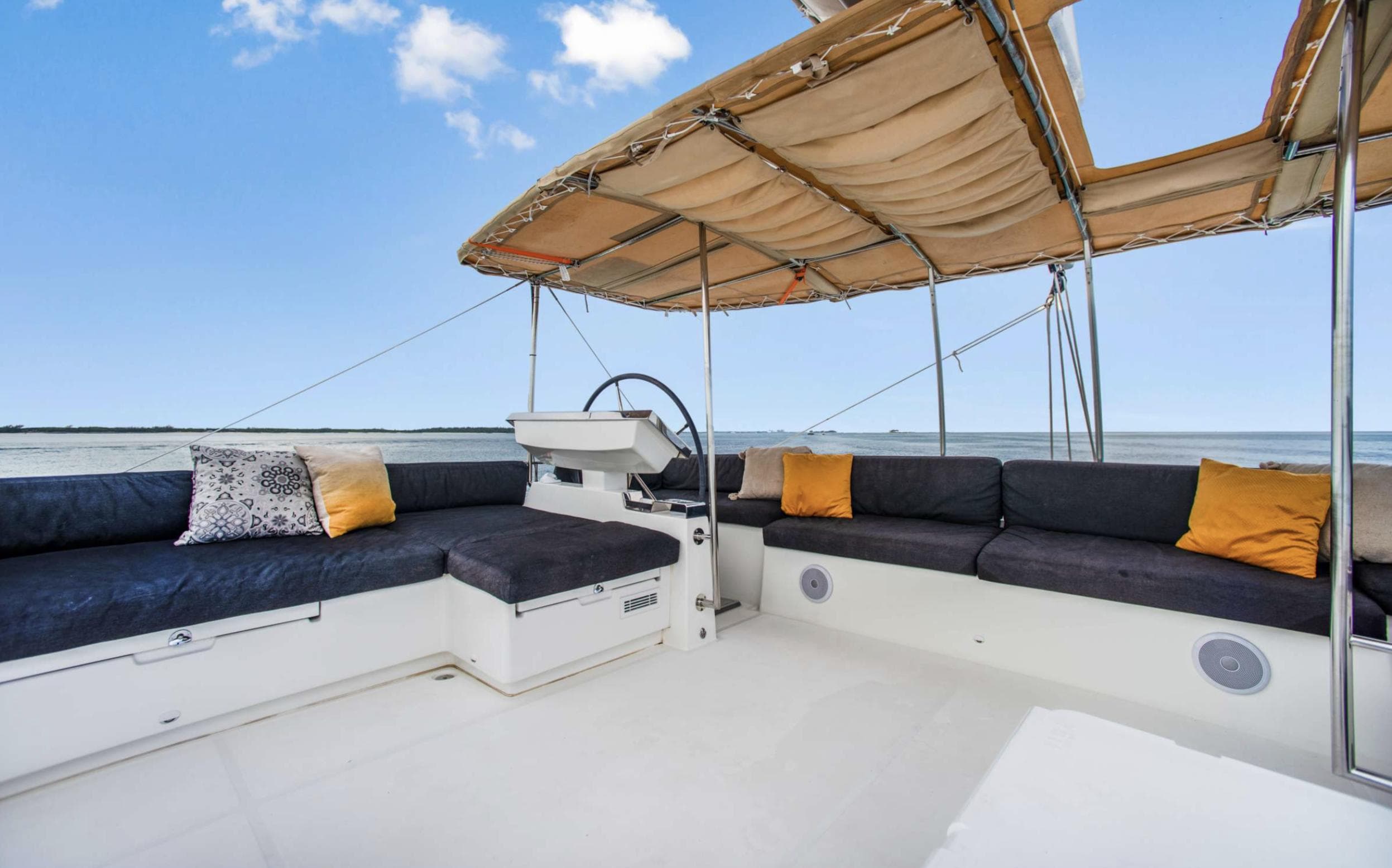 Luxurious Lagoon 620 yacht deck with comfortable seating and canopy, 2020 model.