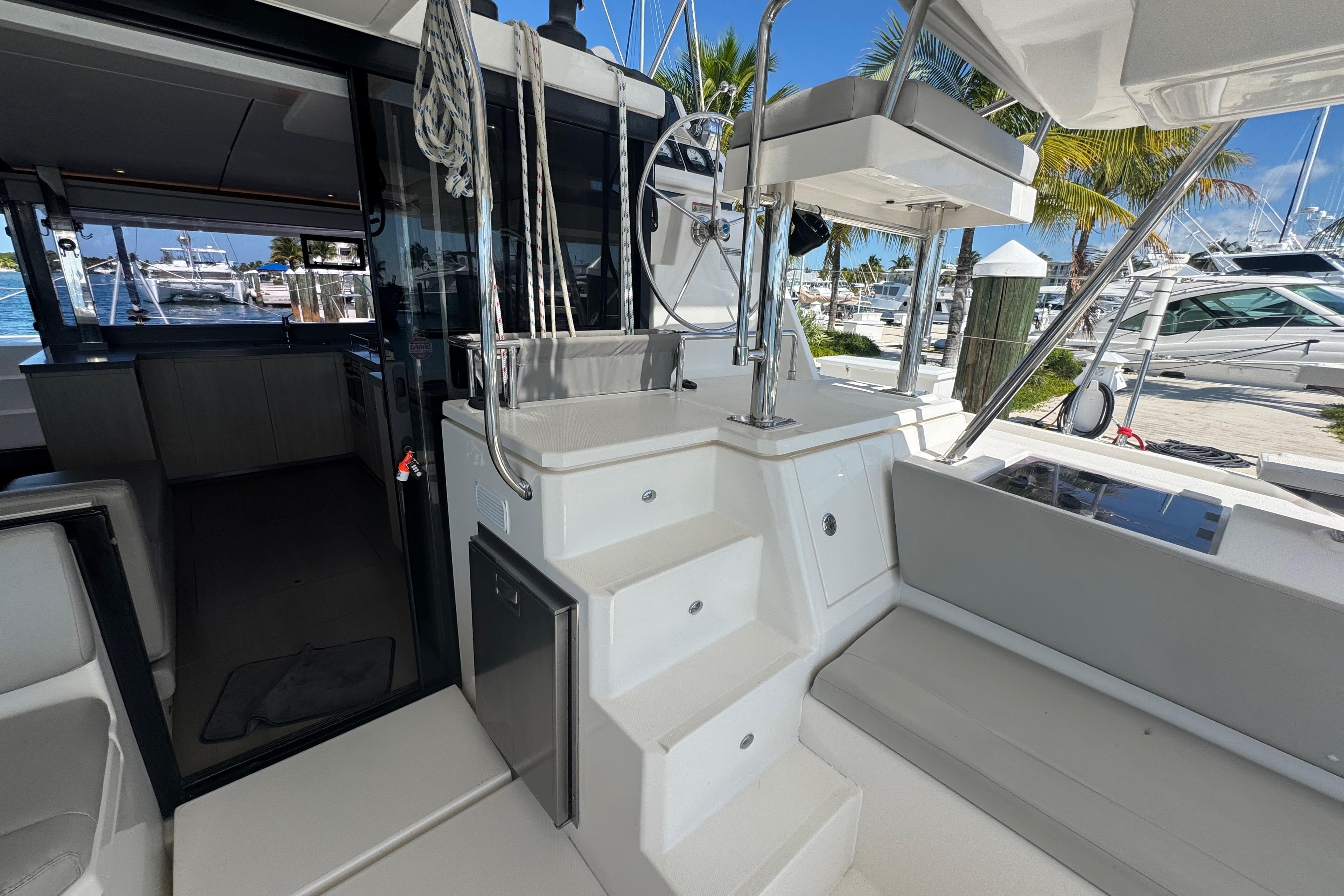 Interior view of a 2021 Leopard 45 catamaran, showcasing modern design and marina backdrop.