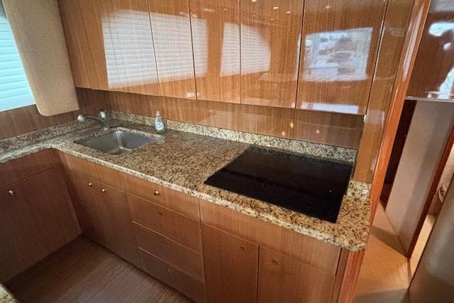 Luxurious kitchen in 2007 Viking 52 Convertible yacht with granite countertops and modern appliances.