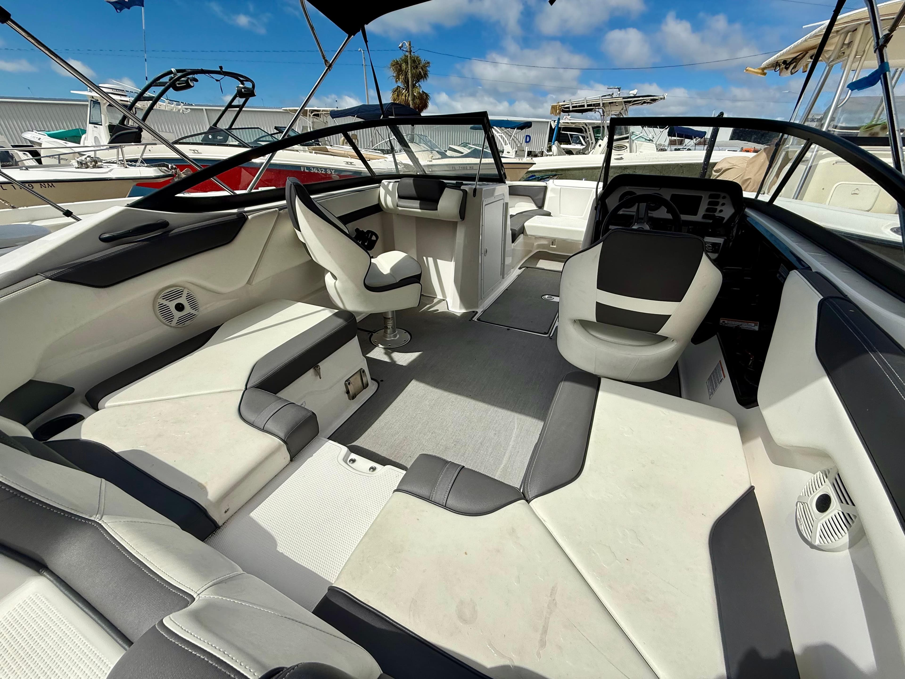 2022 Yamaha Boats SX210 interior with modern seating and sleek design under a clear blue sky.