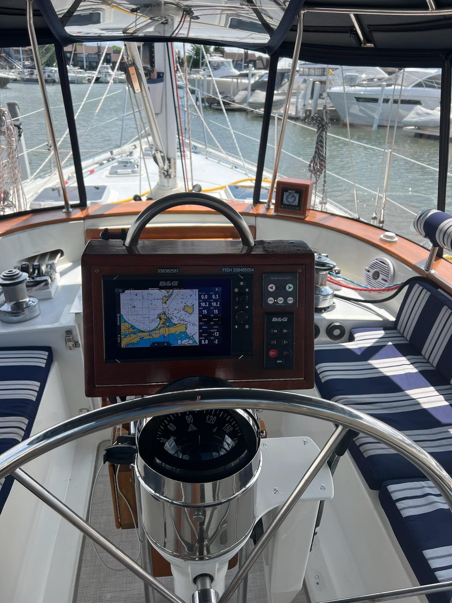 Cockpit of 1992 Endeavour 45 sailboat with navigation equipment and striped seating.