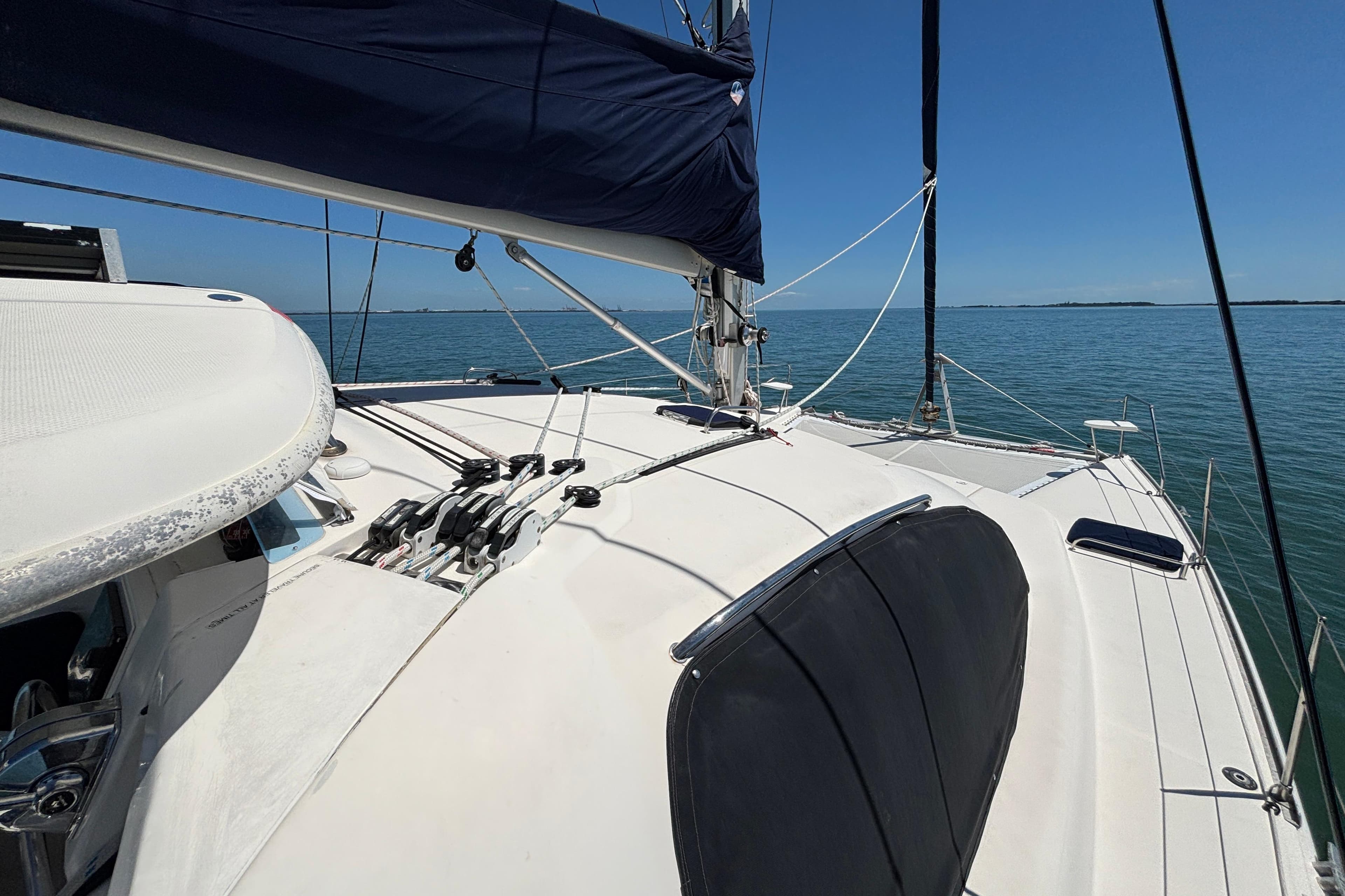 Sailing on a 2007 Leopard 40 catamaran, calm sea, clear blue sky.