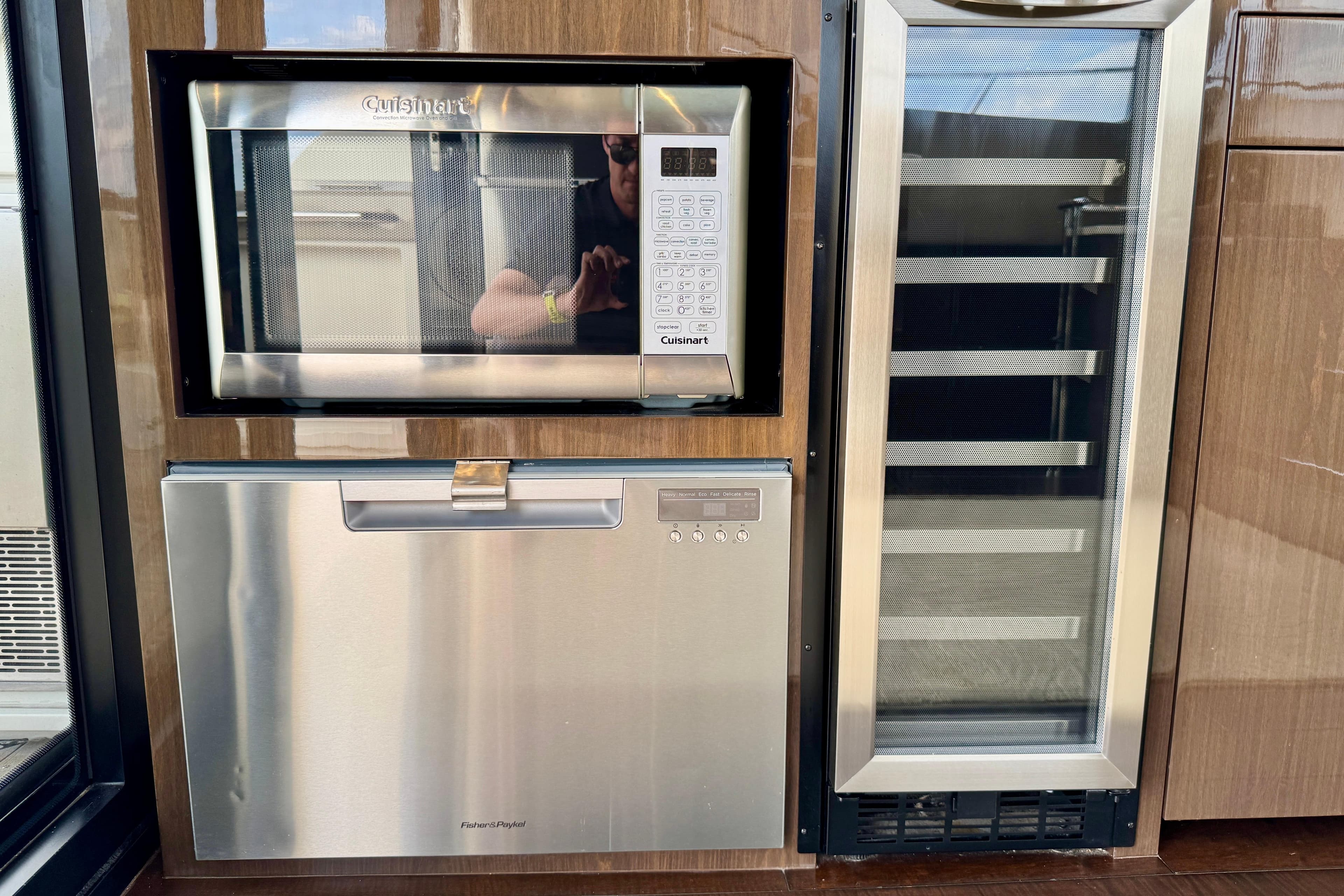 Built-in microwave, dishwasher, and wine cooler in 2018 Carver C52 Coupe yacht kitchen.