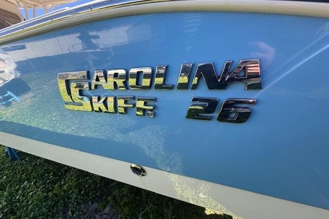 2024 Carolina Skiff 26 Ultra Elite boat logo on blue hull.