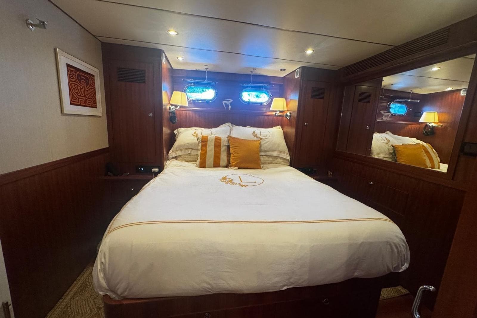 Luxurious cabin interior of 2025 Nordhavn 475 yacht with elegant bedding and warm lighting.