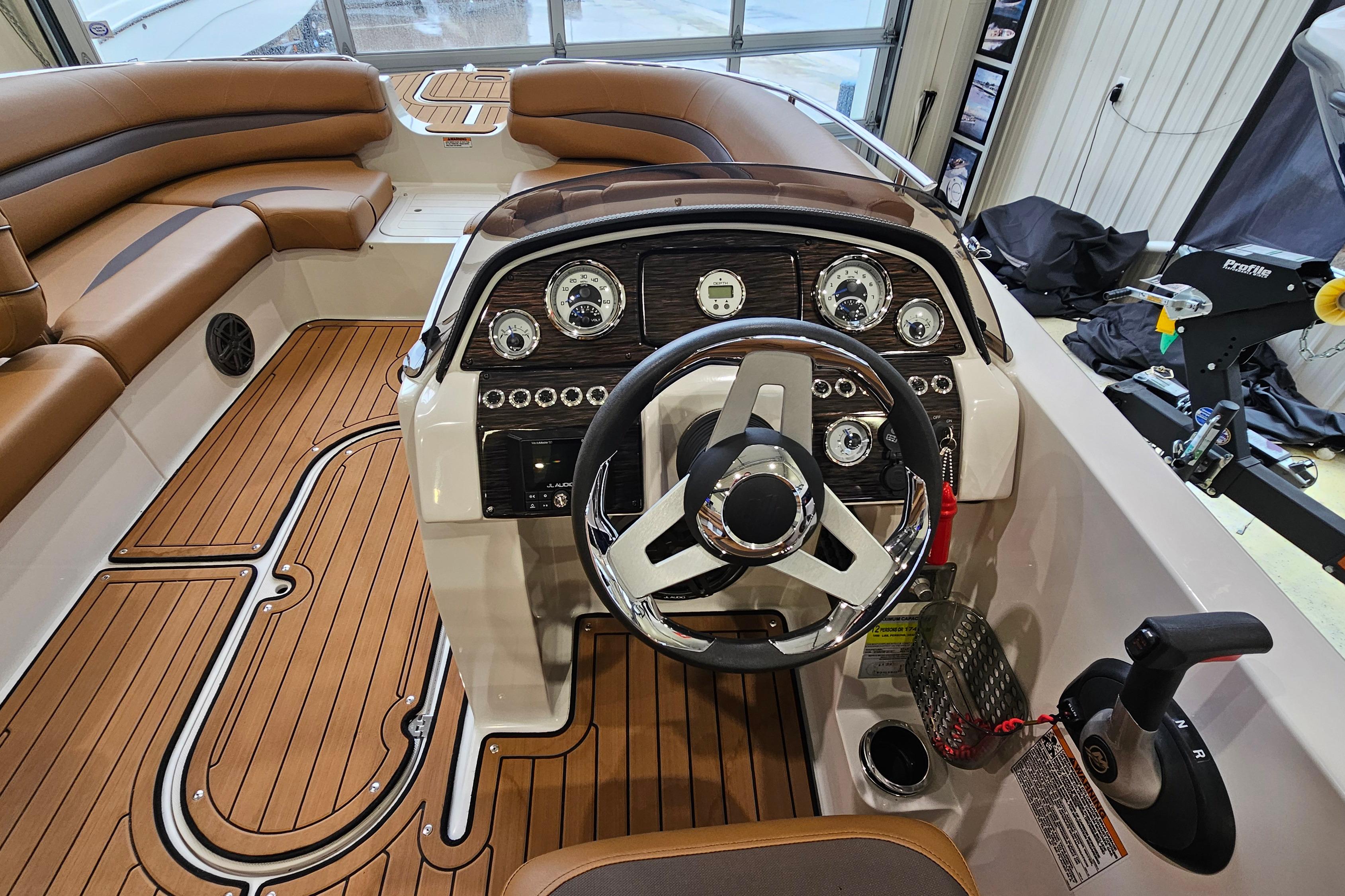 2022 Starcraft Star Step 221 E I/O boat interior with sleek dashboard and wood-style flooring.