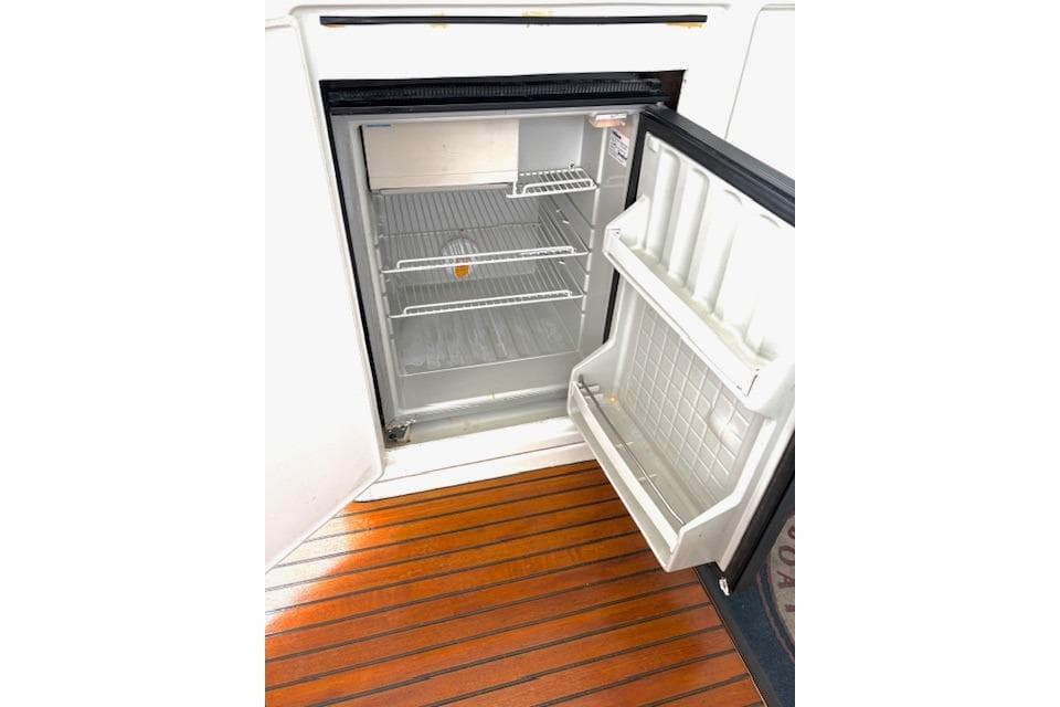 Open refrigerator on Lagoon 440 yacht, 2008 model, with wooden flooring.