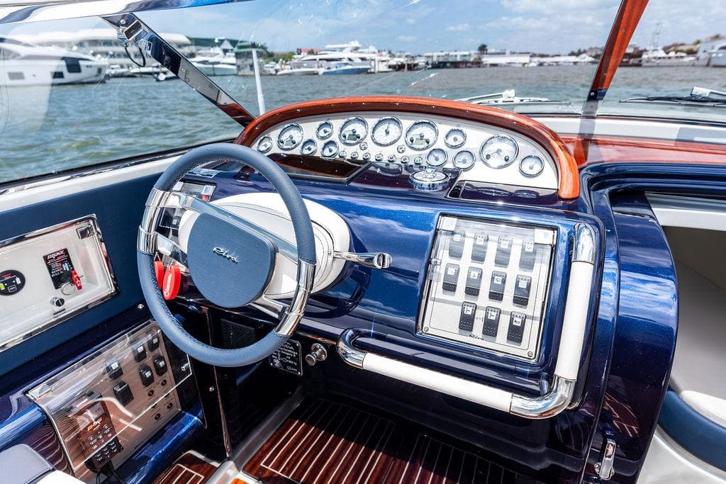 Interior of a 2015 Riva Aquariva Super boat, featuring a sleek dashboard and steering wheel.