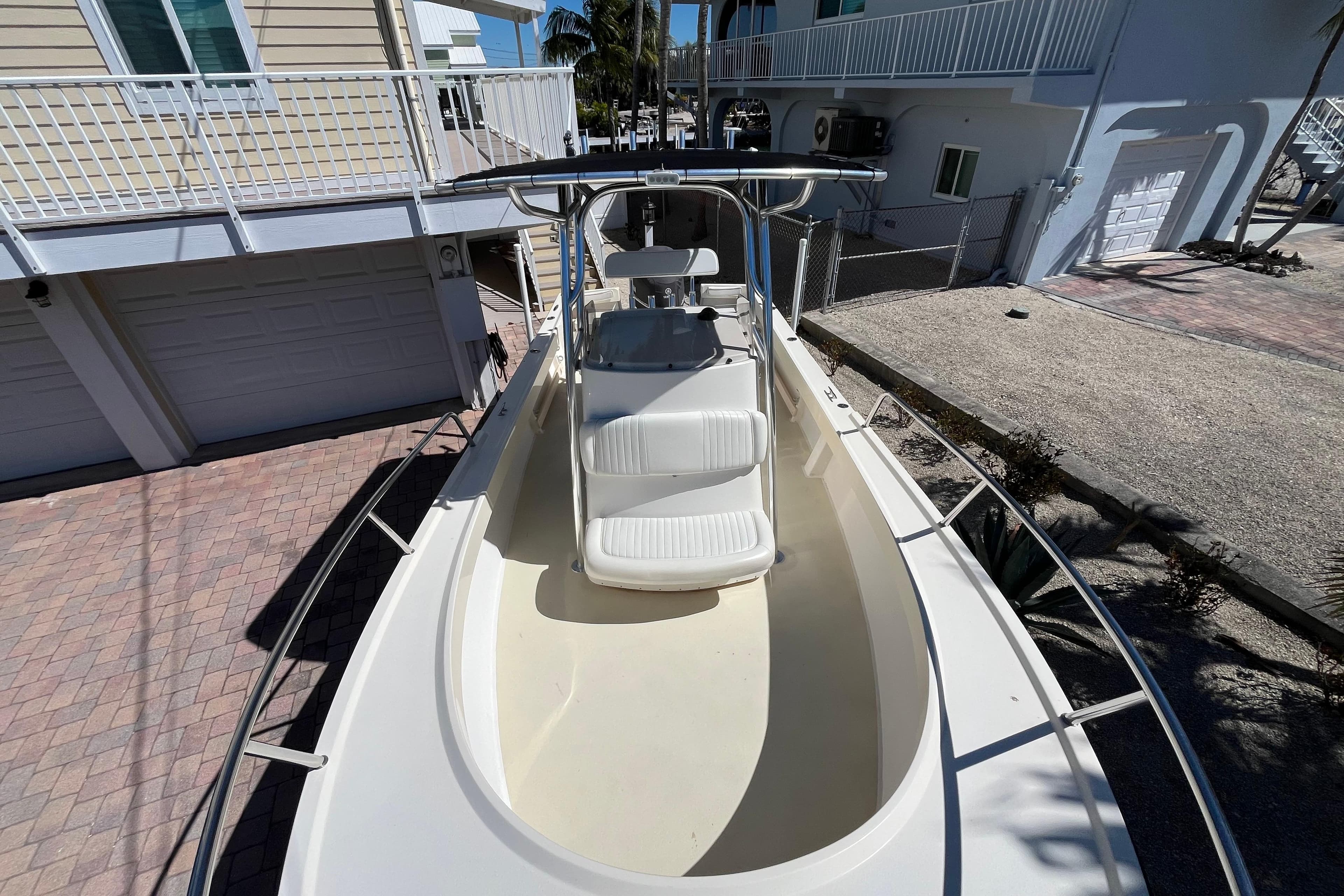 2009 Parker 2300 Special Edition boat docked near residential buildings.