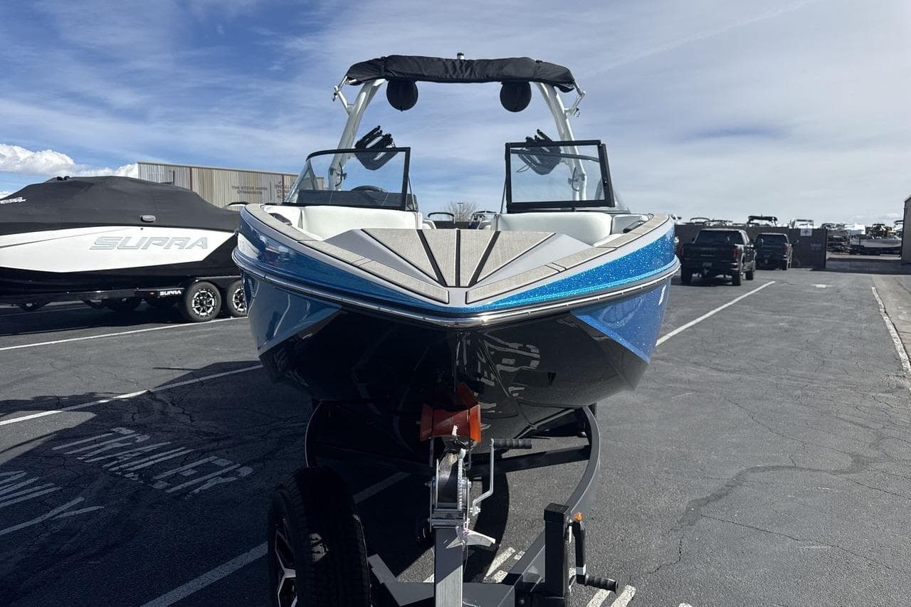 2025 Moomba Craz boat on trailer, parked outdoors under clear sky.