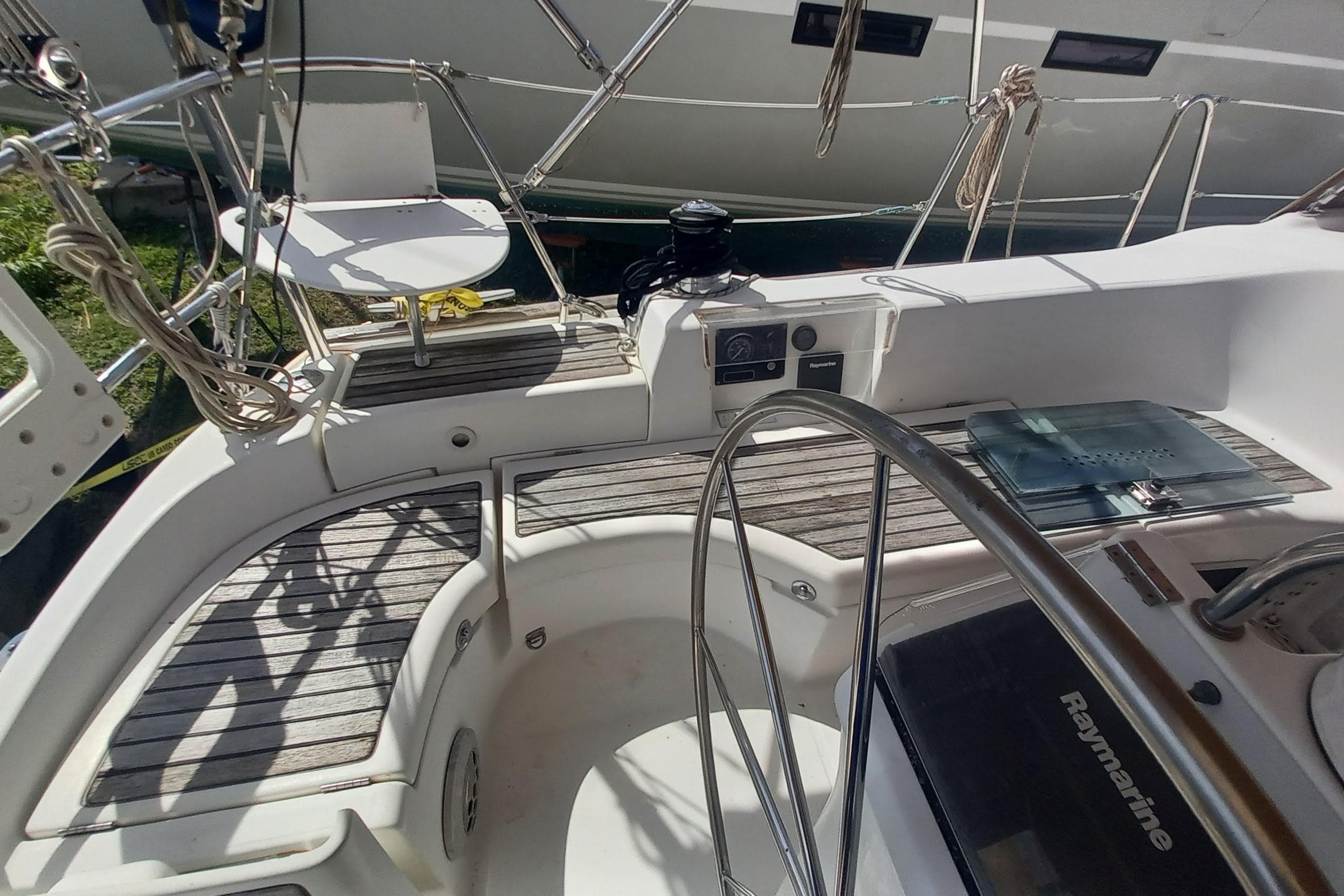 Cockpit of 2007 Beneteau 423 sailboat with steering wheel and navigation equipment.