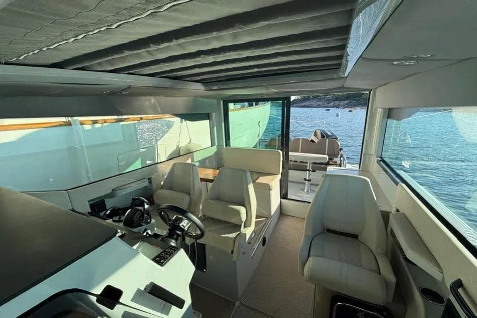Interior of 2022 Saxdor 320 GTC boat with modern seating and steering area.