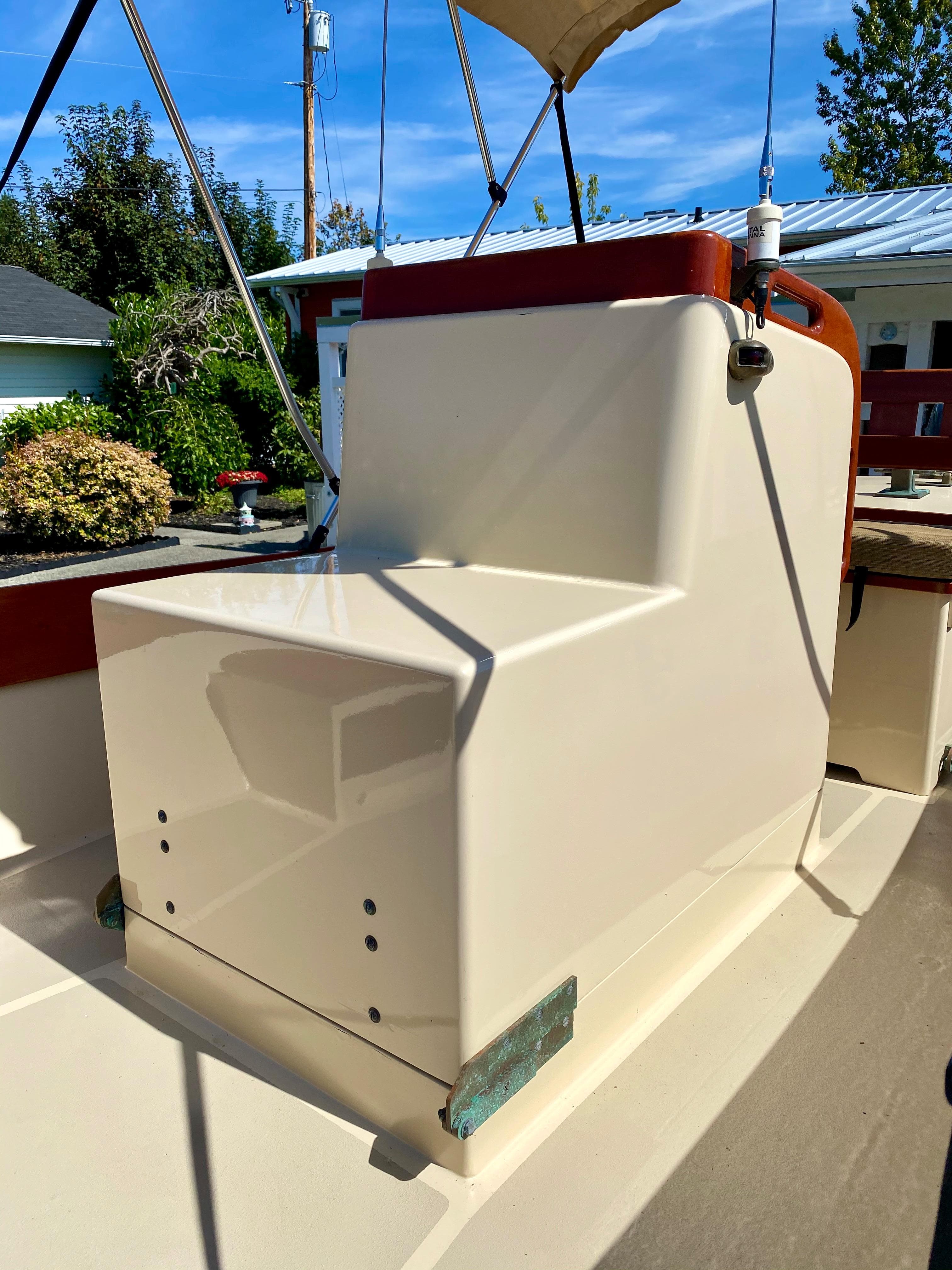 2014 Stimson Ocean Pointer Launch boat with beige seating and canopy, docked outdoors.