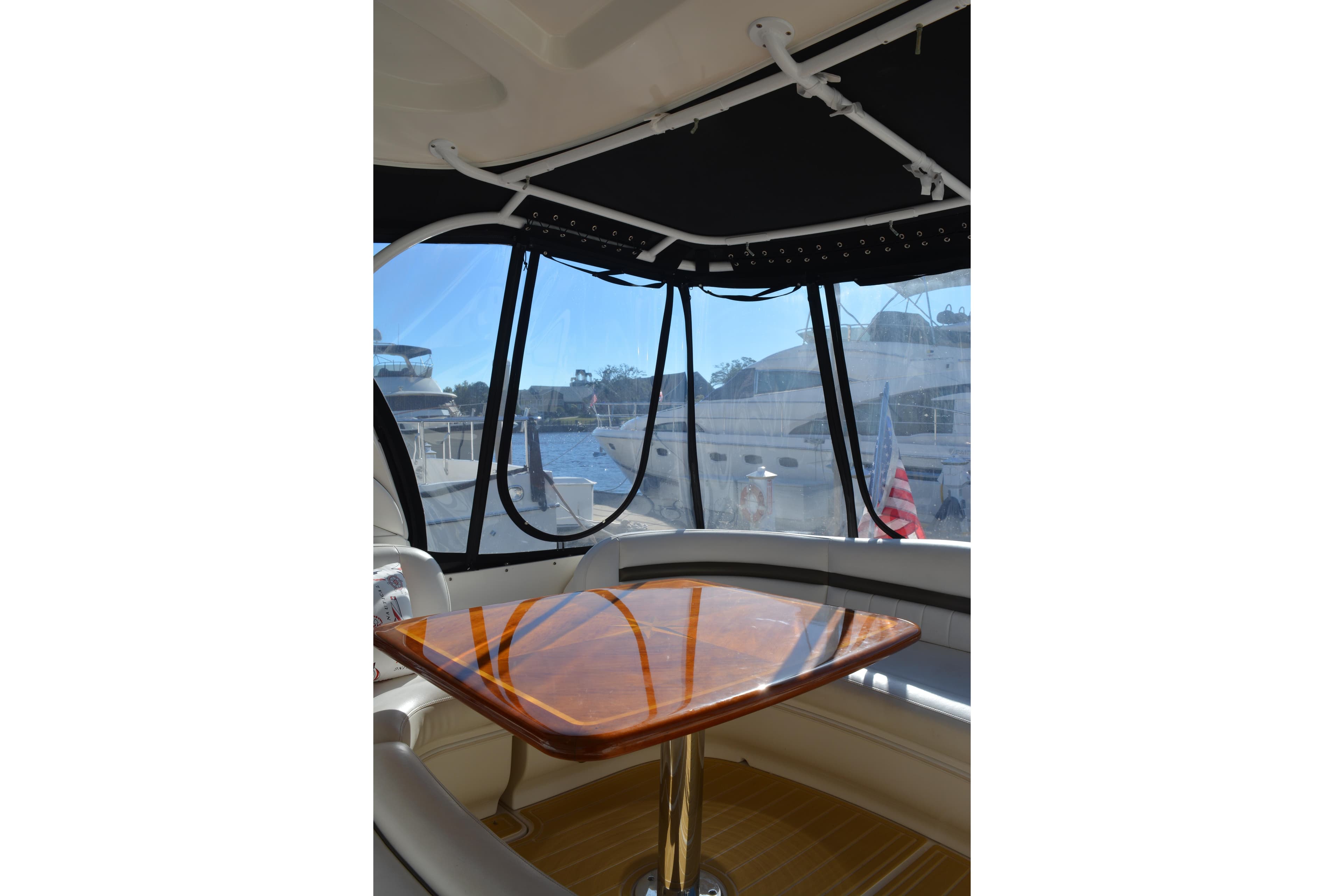 Interior view of 2007 Sea Ray 44 Sundancer yacht with polished wooden table.