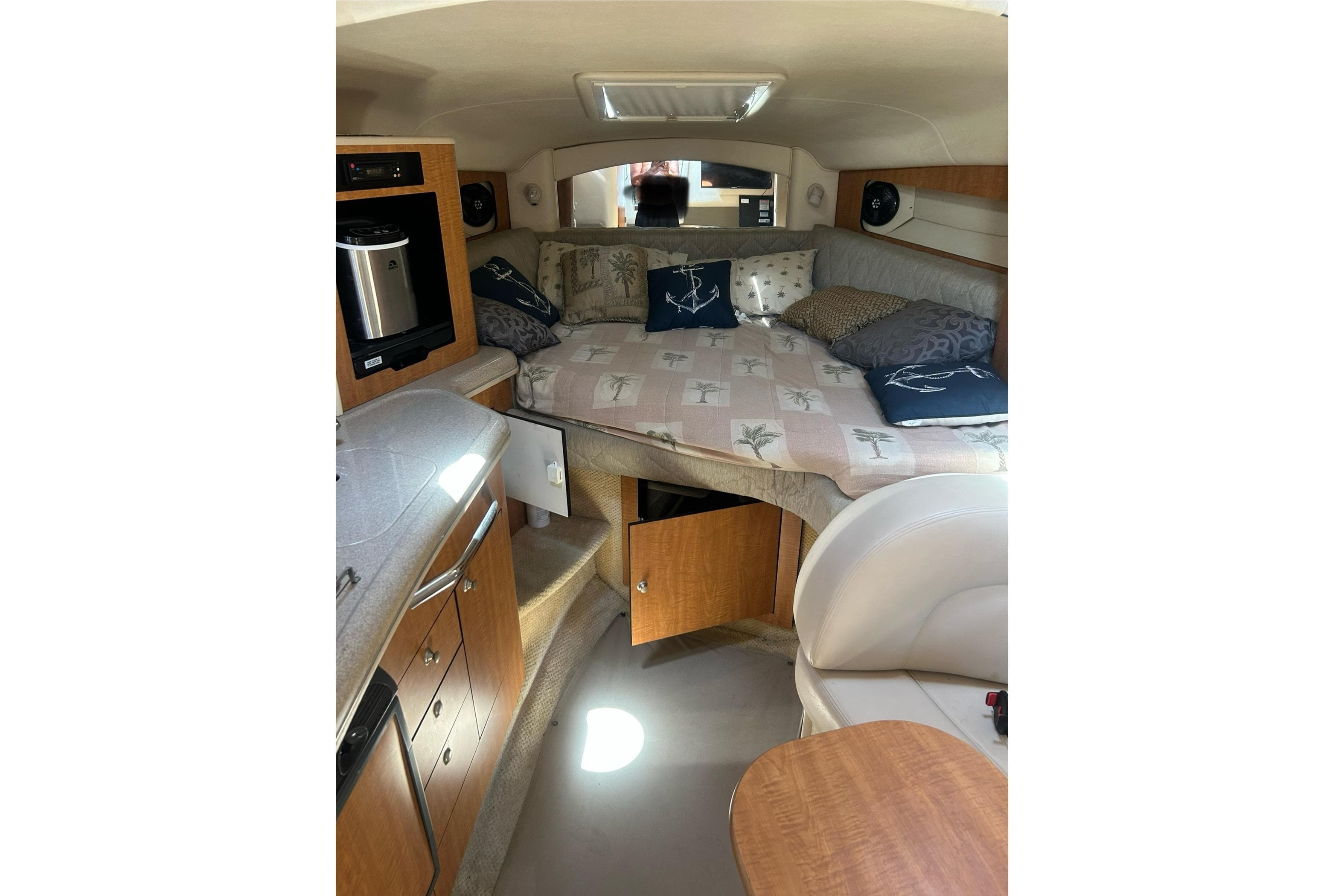 Interior of 2006 Sea Ray 300 Sundancer with cozy cabin and kitchenette.