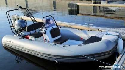 2024 Grand Inflatables S420 boat docked on calm water.