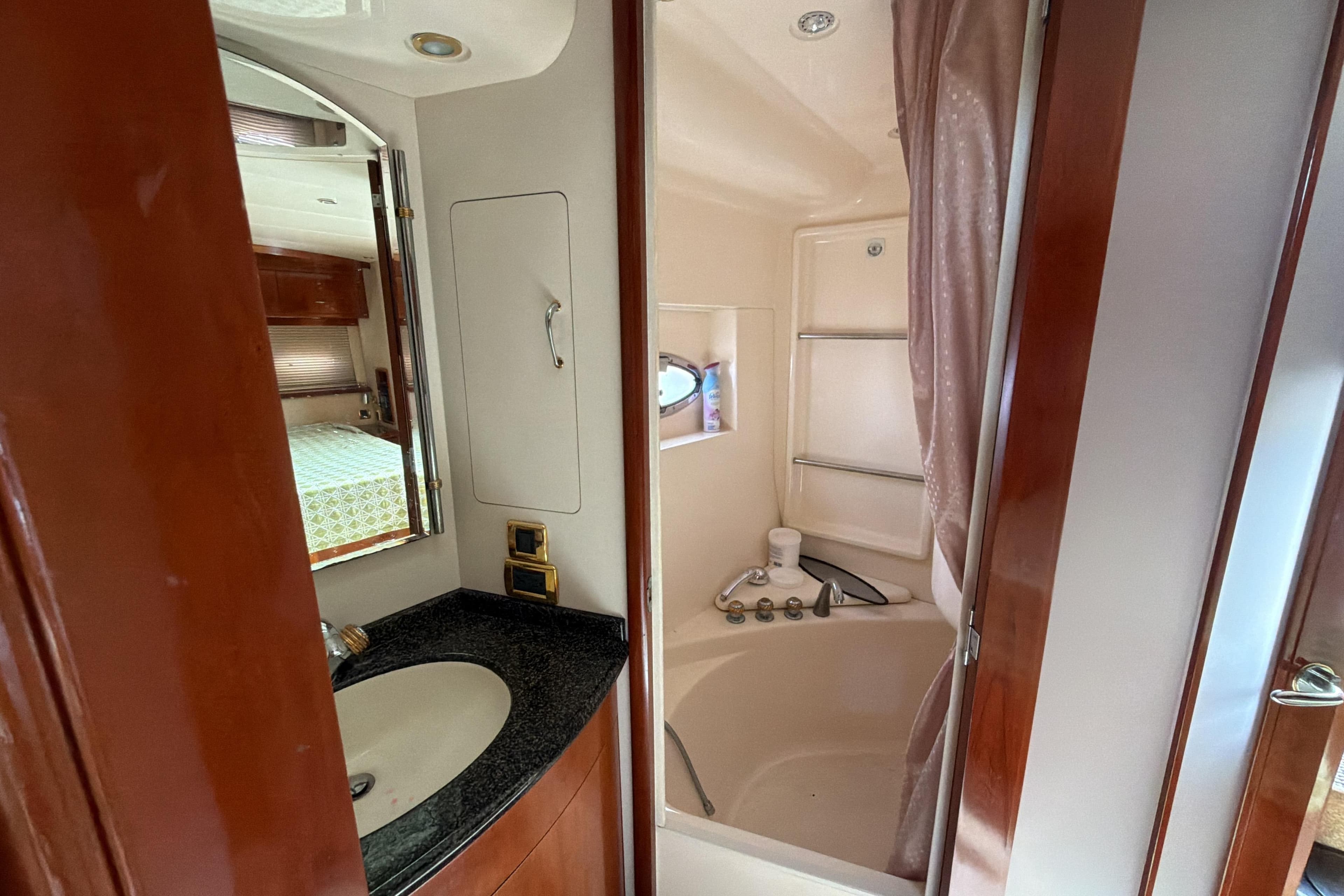 Bathroom interior of 2003 Carver 564 Cockpit Motor Yacht with sink and shower.