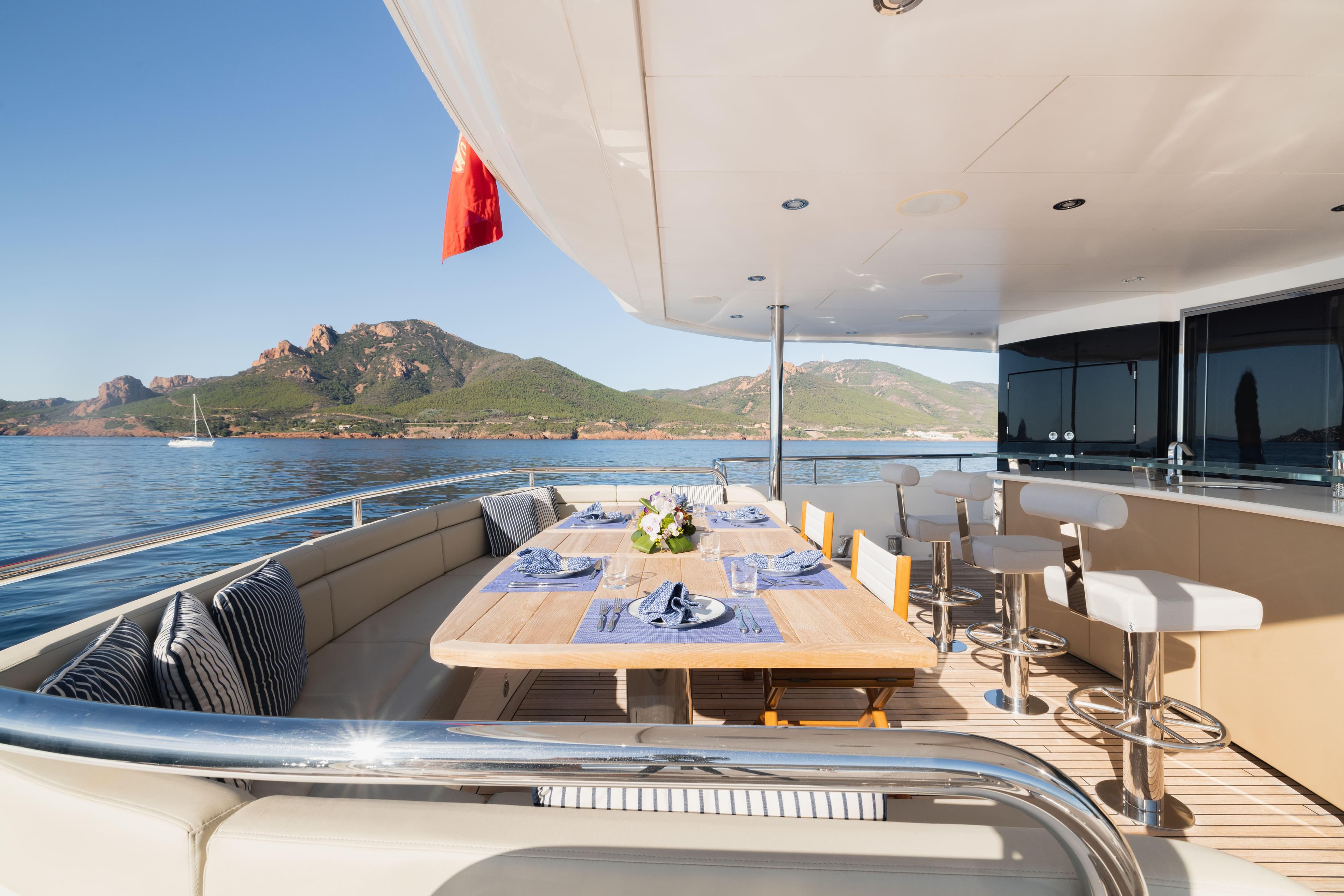 Luxurious Sunseeker 116 Yacht 2016 with elegant outdoor dining area and scenic ocean view.