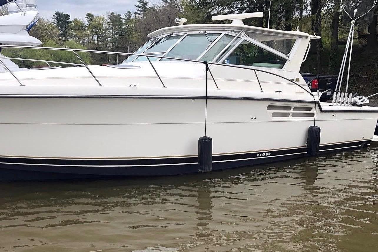 1998 Tiara Yachts 4100 Open boat docked on calm water.
