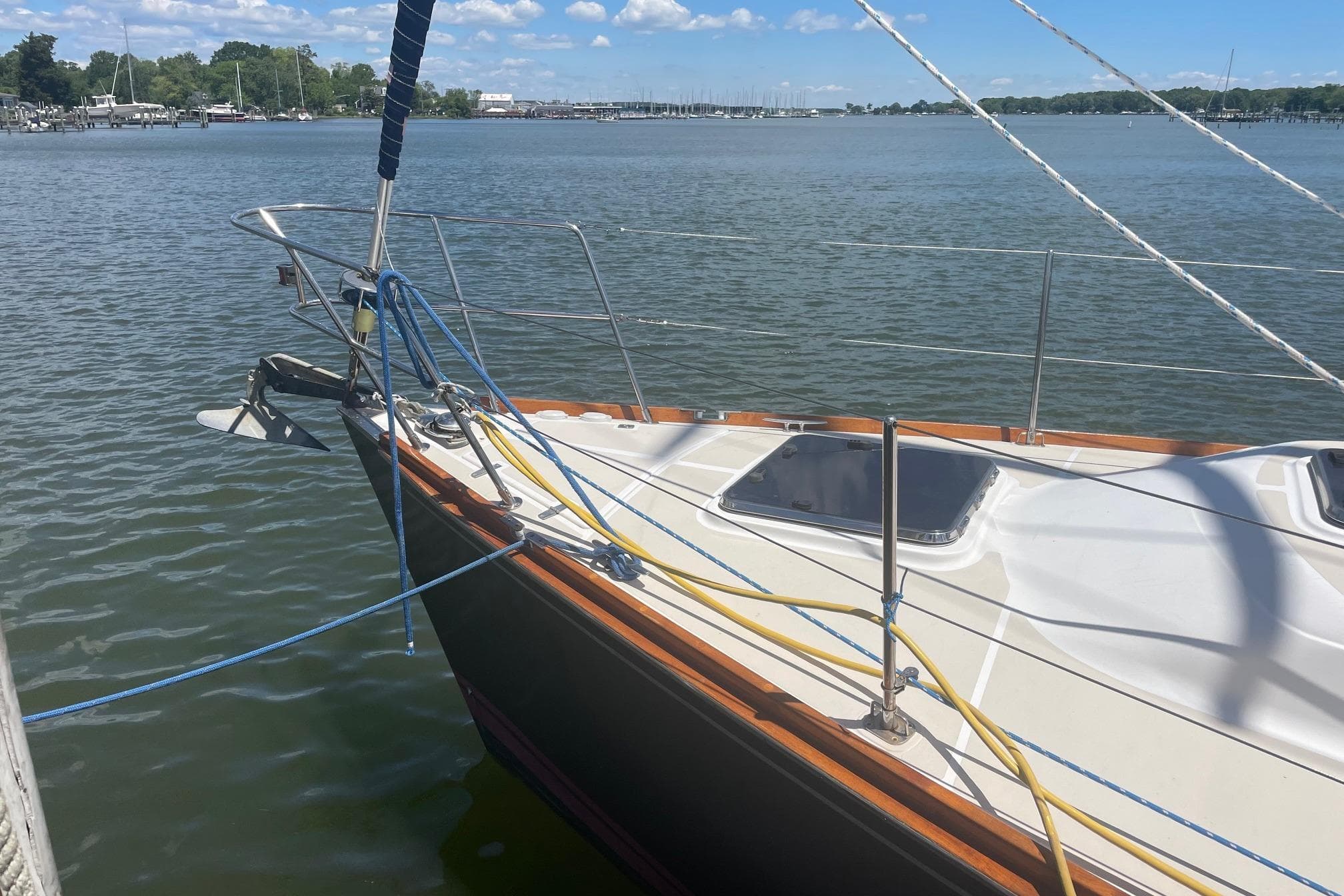 Sailboat Tartan 3700 (2001) docked on calm water under a clear sky.