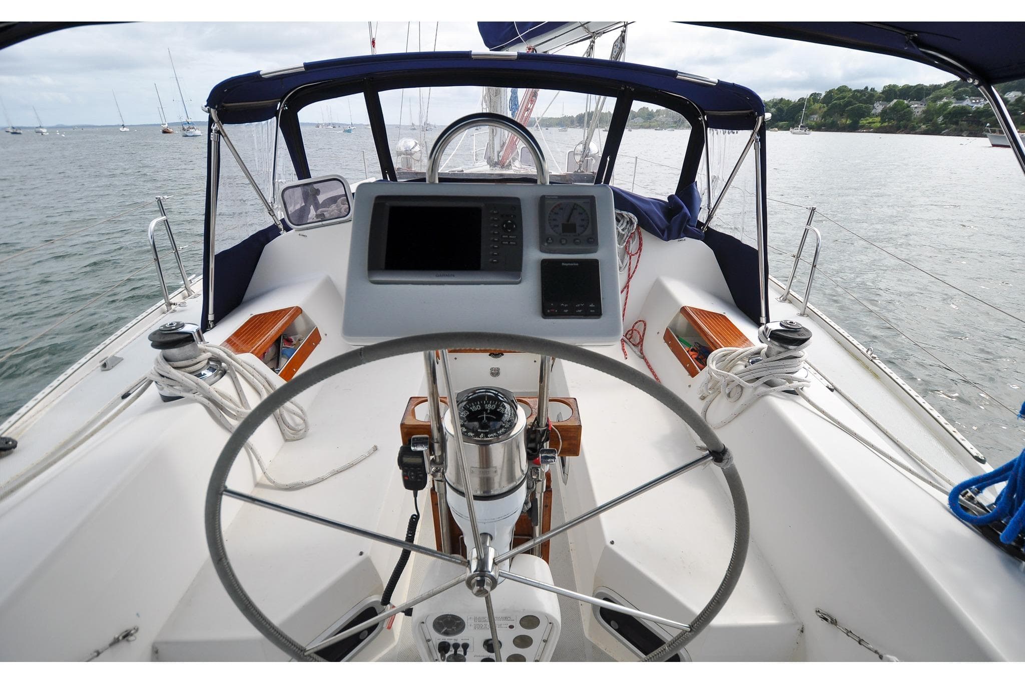 Cockpit view of a 1993 Catalina 42 sailboat with steering wheel and navigation instruments.