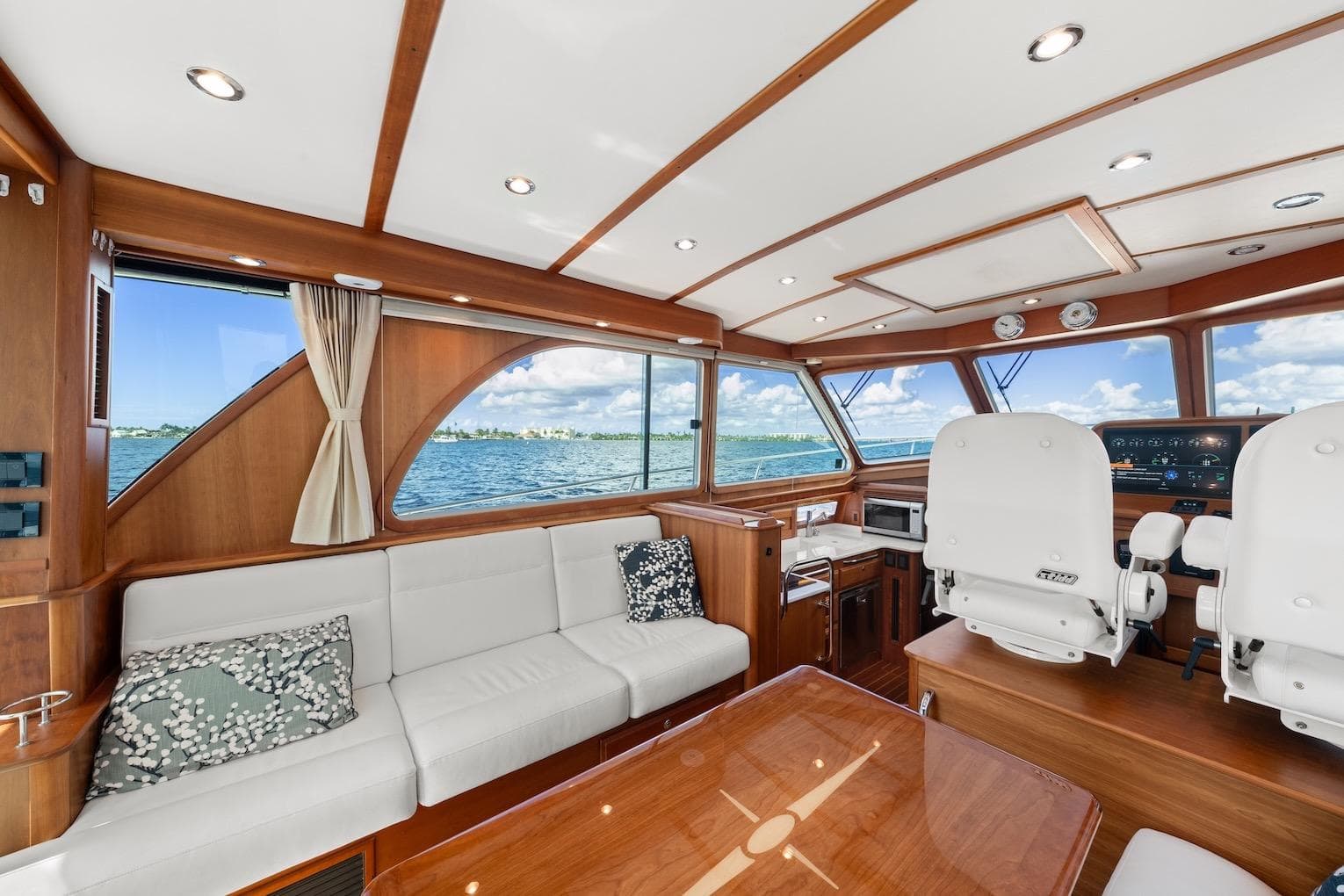 Luxurious interior of 2019 Sabre 45 Salon Express yacht with panoramic windows and elegant seating.