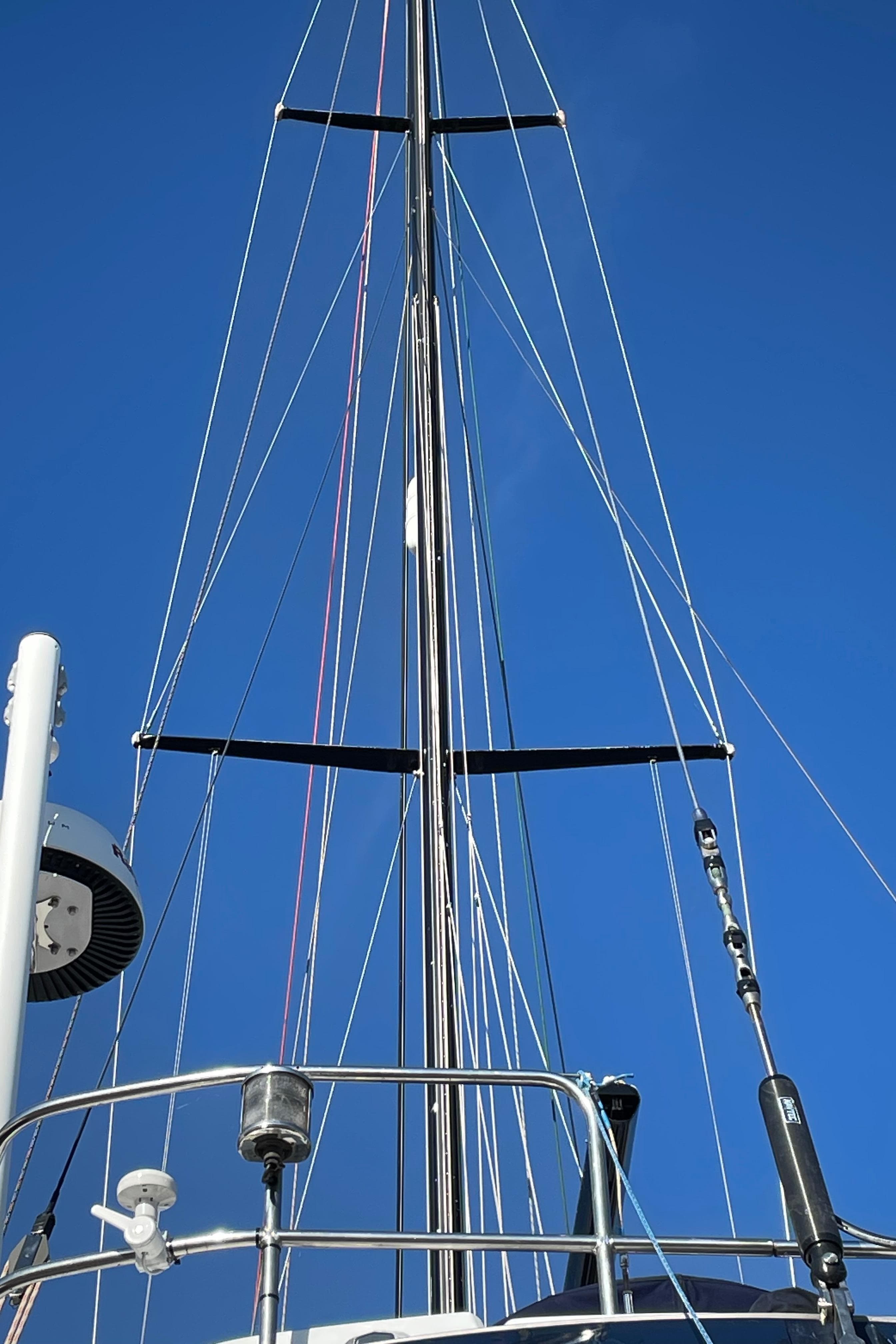 Mast of a 1982 Baltic 42 sailboat against a clear blue sky.