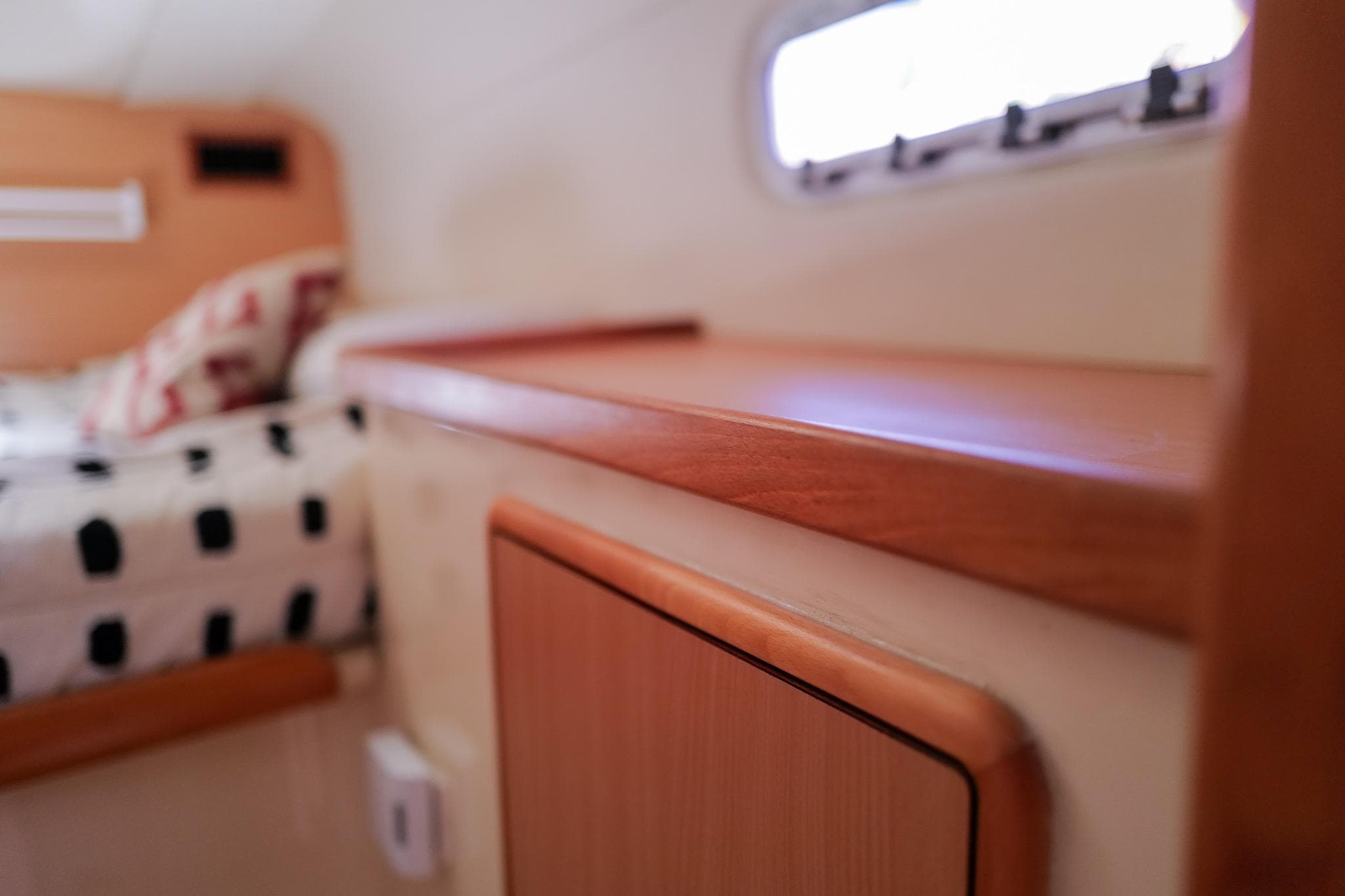 Interior of 2006 Leopard 43 yacht cabin with wooden finish and patterned bedding.