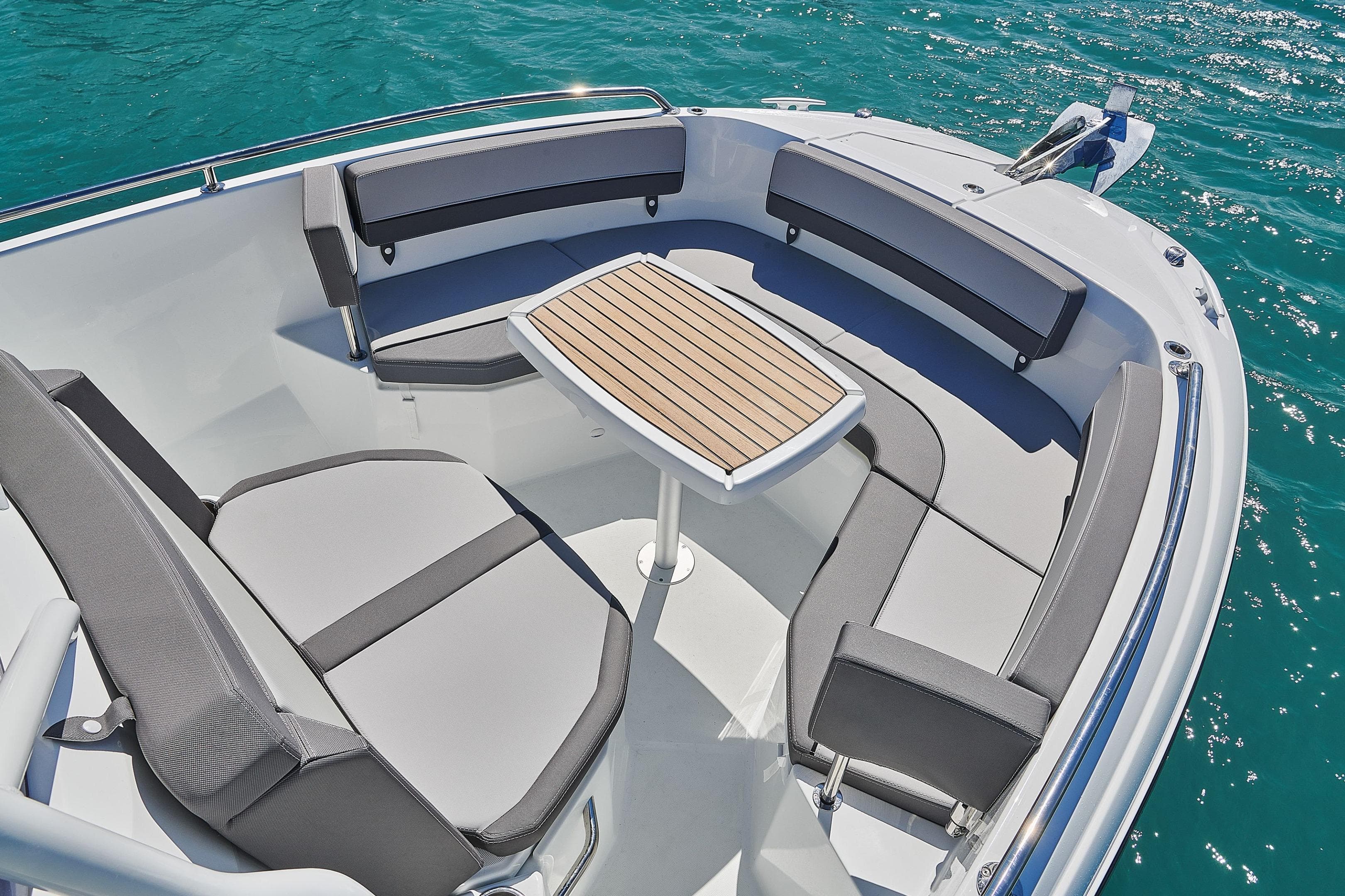 2026 Jeanneau Leader 7.5 CC boat interior with seating and table on blue water.