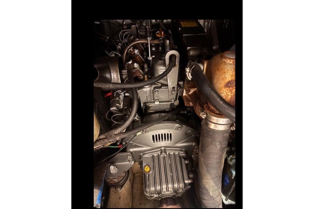 Engine compartment of a 1990 C&C 37/40 Plus sailboat, showcasing mechanical components.