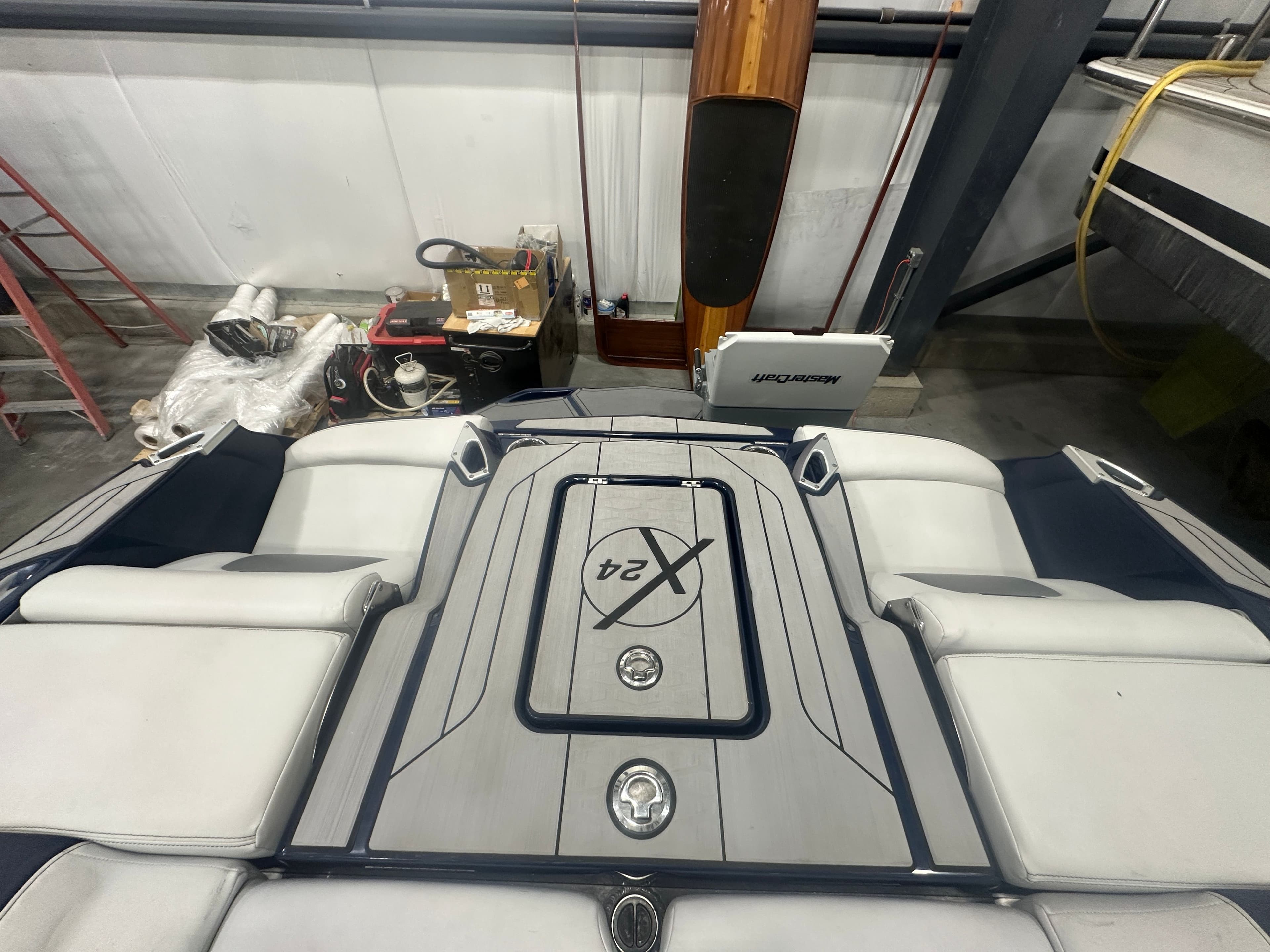 2019 MasterCraft X24 boat interior with cushioned seating in a storage facility.