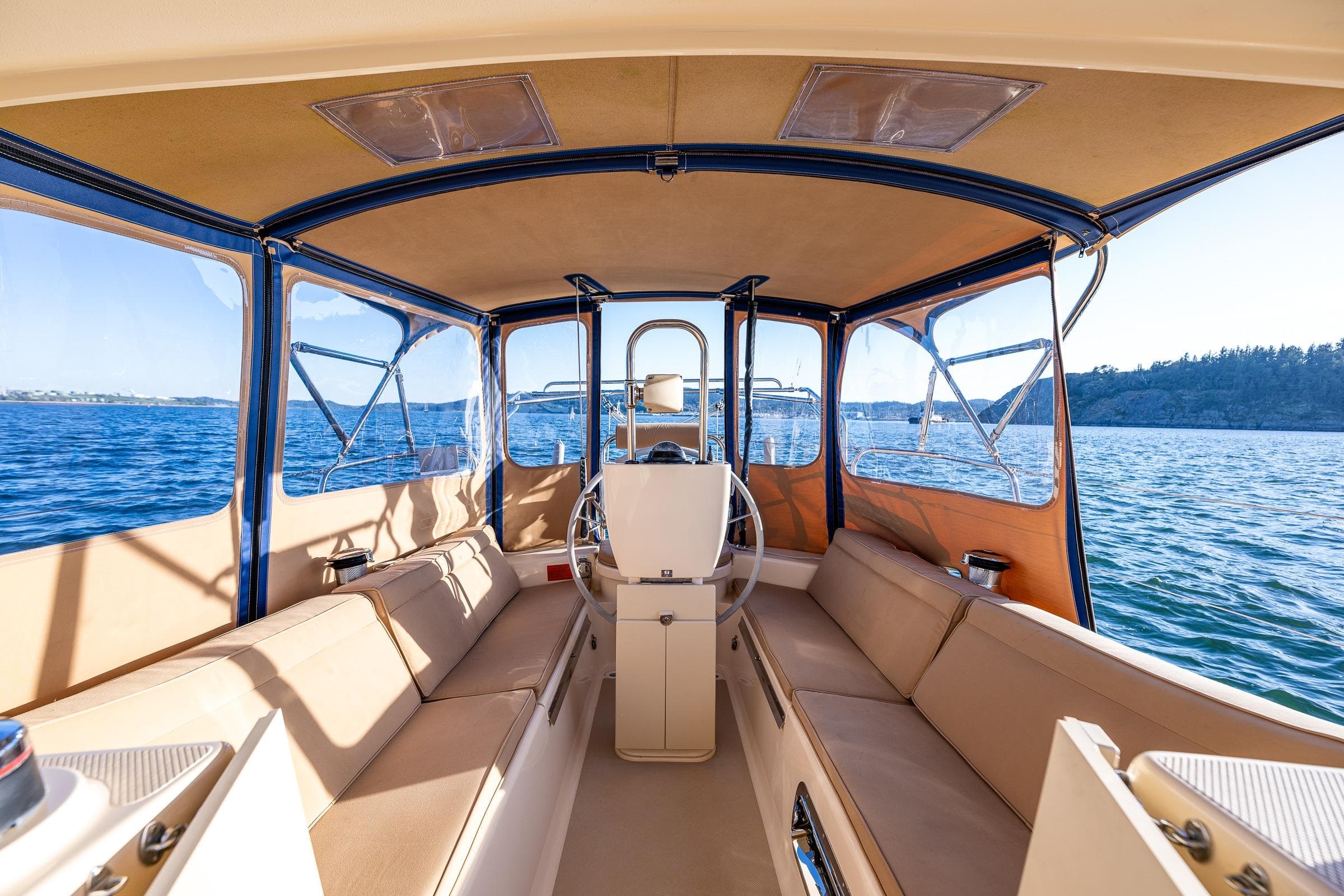 Interior view of 2020 Island Packet 349 sailboat with spacious seating and panoramic windows.