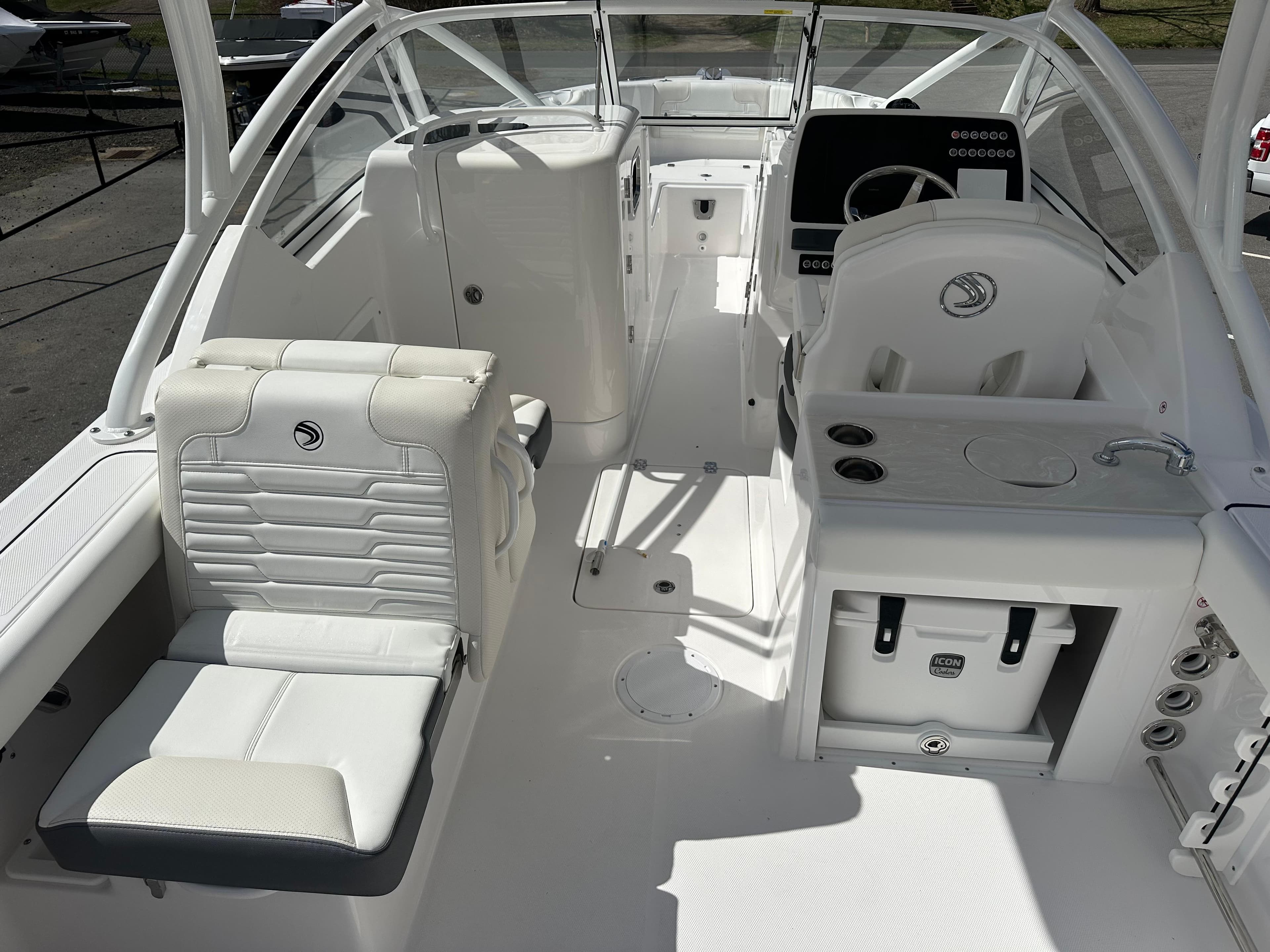 2025 Edgewater 248CX Crossover boat interior with white seating and modern dashboard.