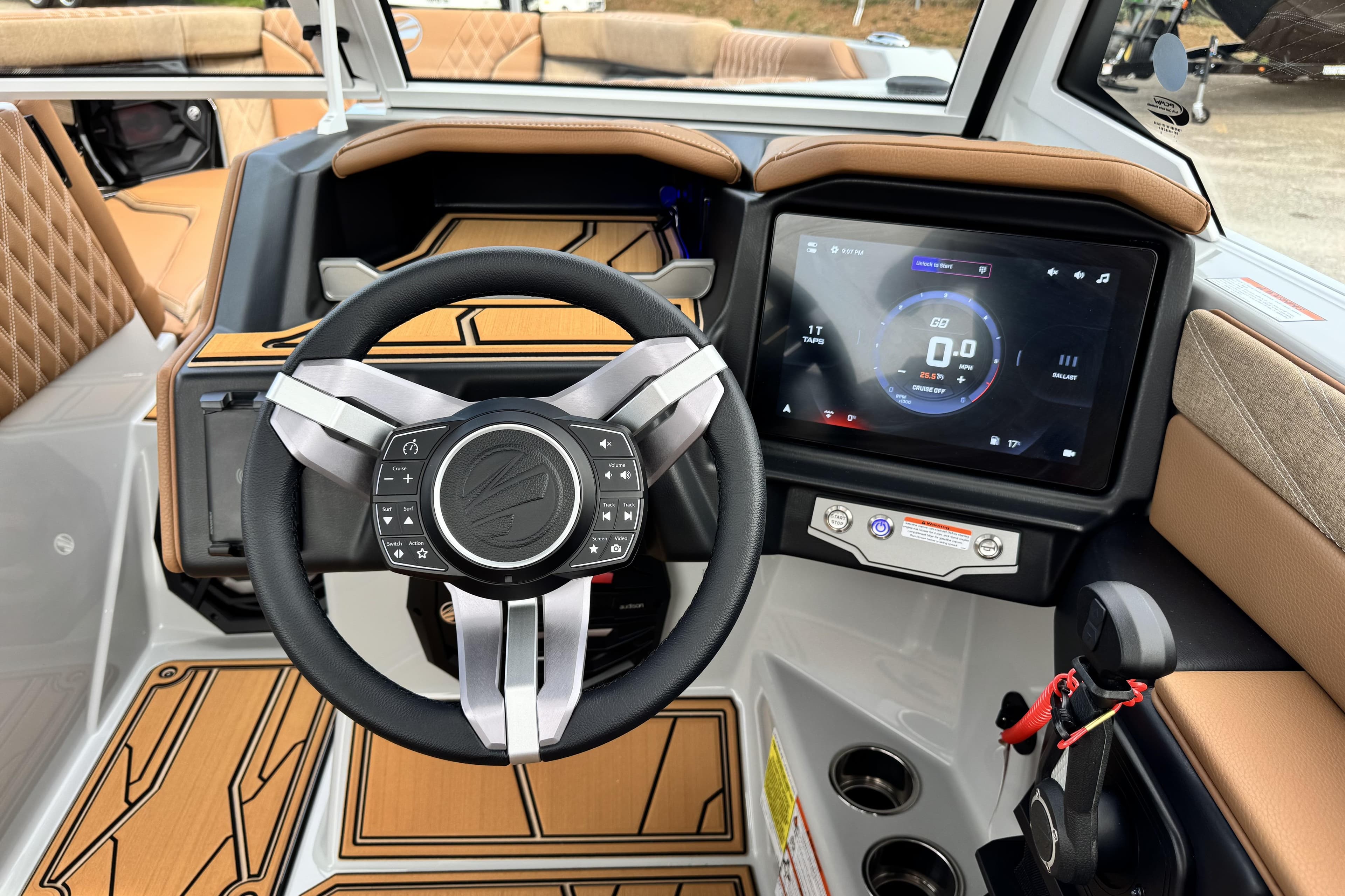 Interior of 2026 Tigé 24RZX boat featuring modern steering wheel and touchscreen display.