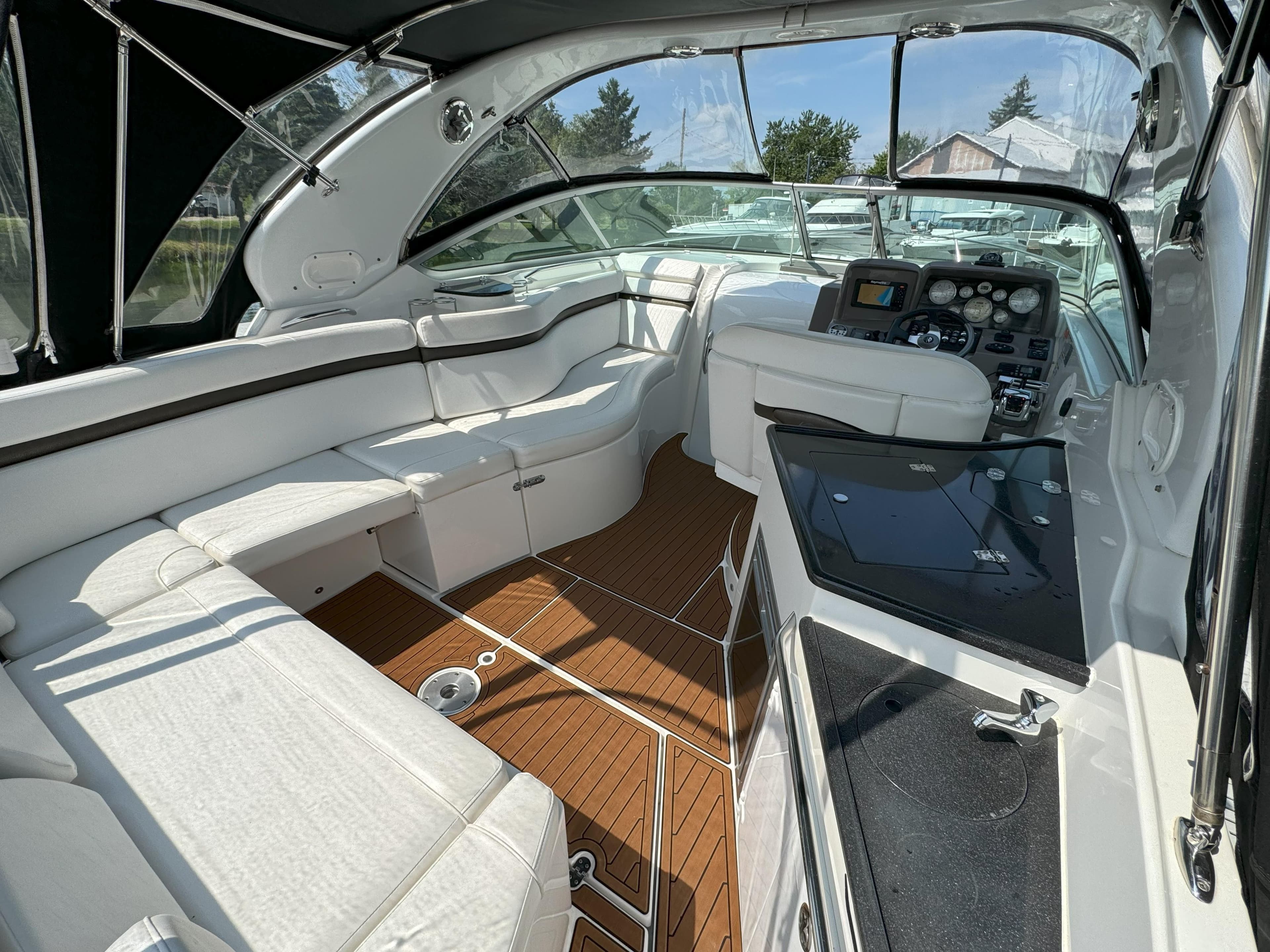 Interior of a 2010 Rinker 310 Express Cruiser with white upholstery.