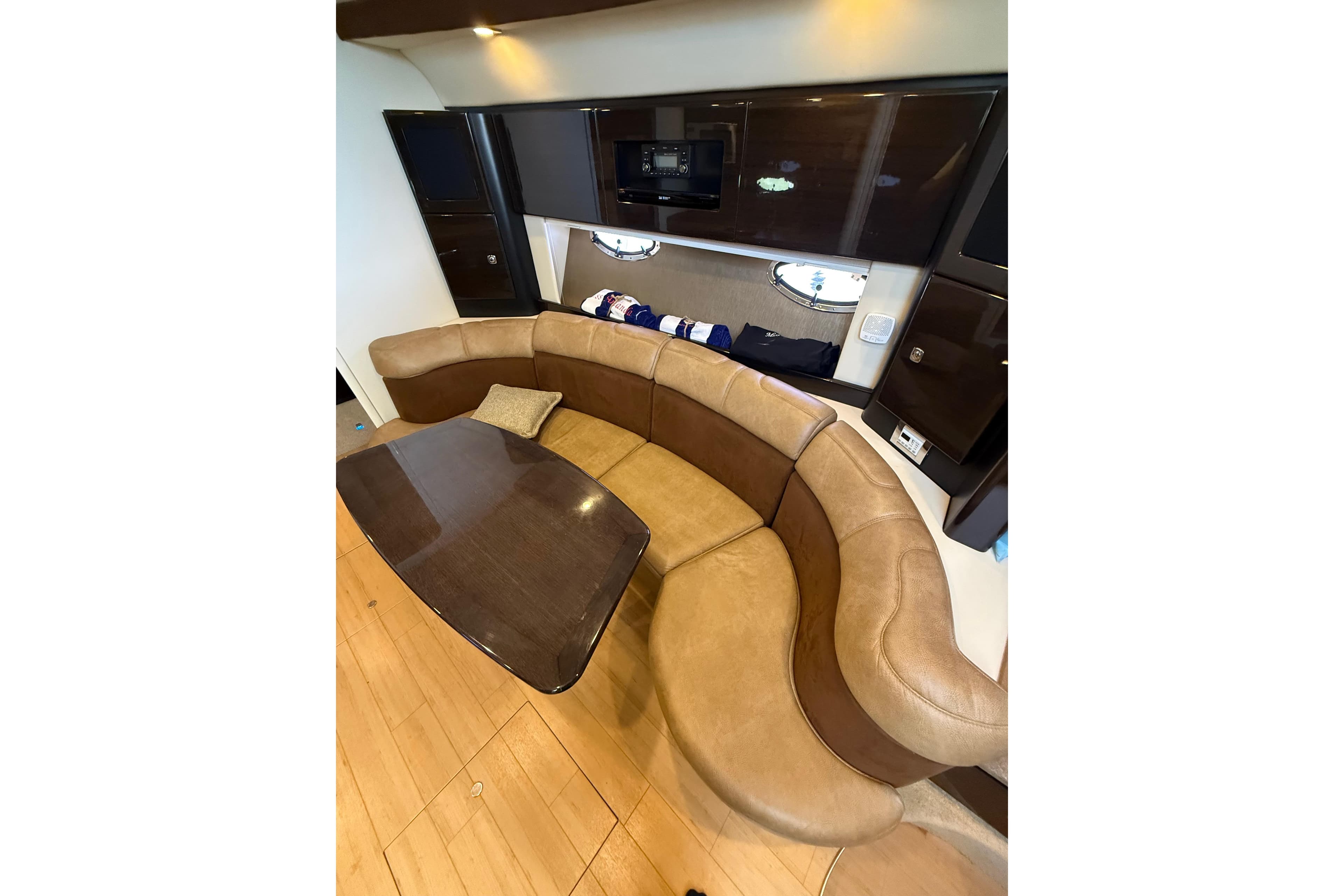 Luxurious interior of a 2014 Formula 37 Performance Cruiser with curved seating and wooden table.