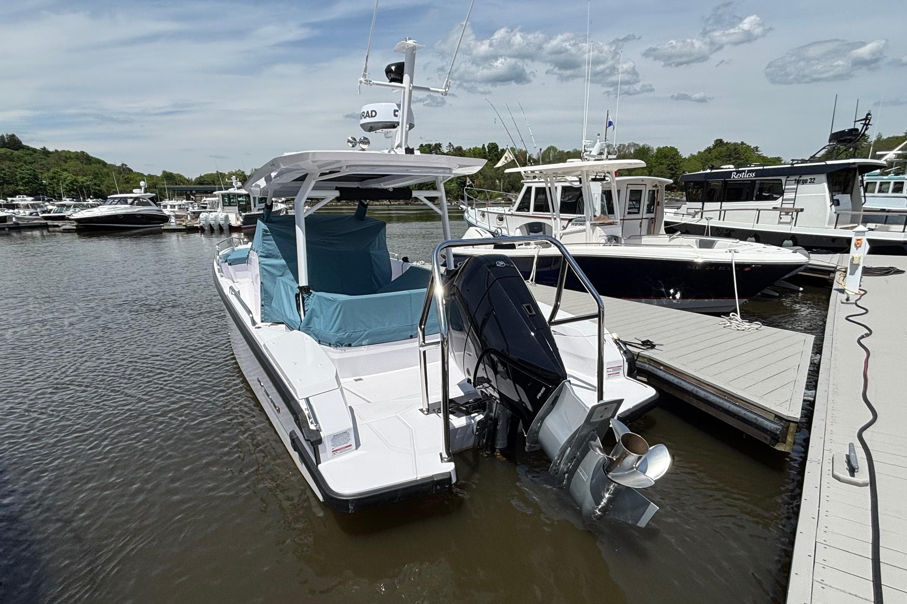 2025 Axopar 29 Sun-Top boat docked at marina, rear view.