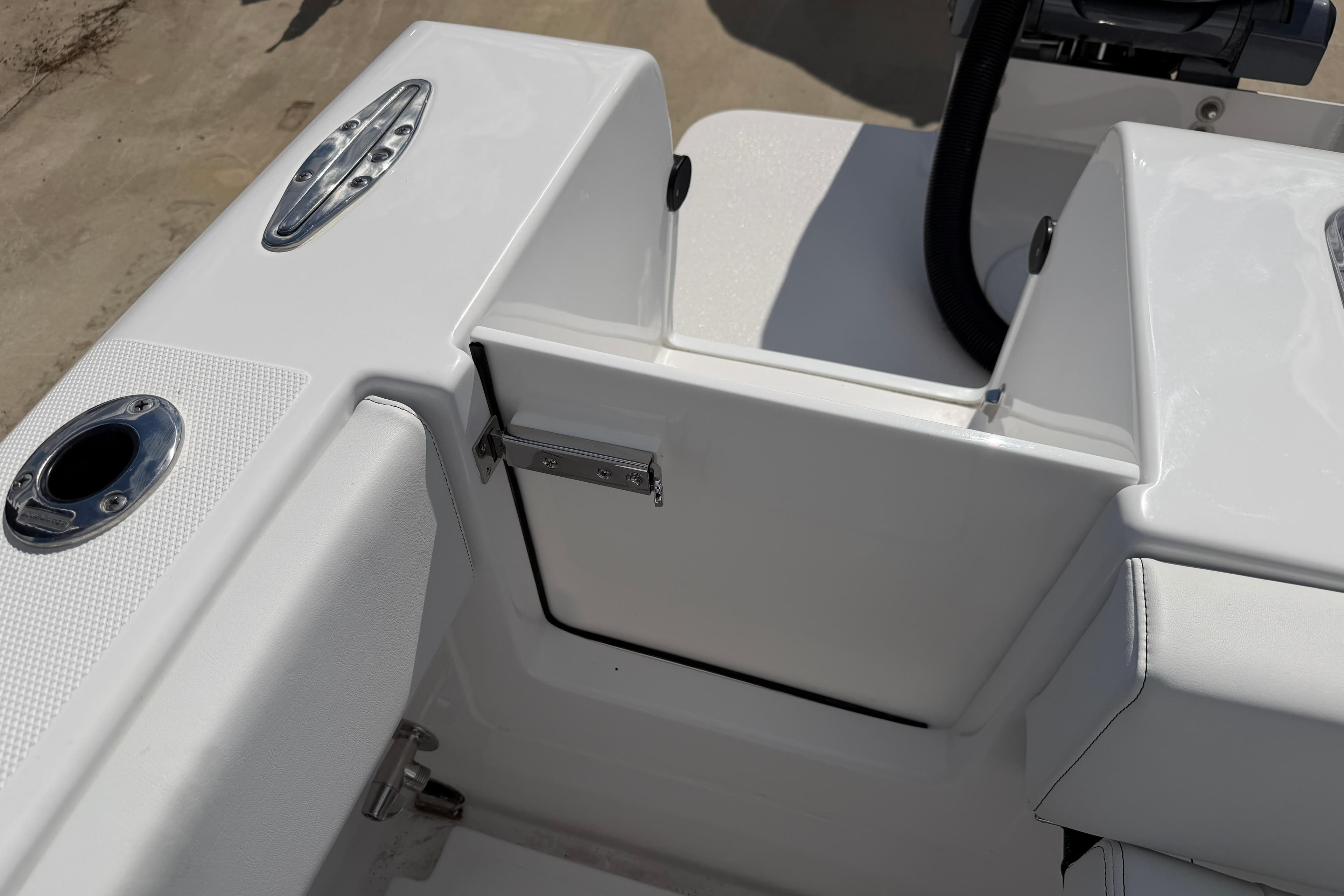 2026 Bluewater Sportfishing 25T boat interior, featuring sleek white seating and stainless steel fixtures.