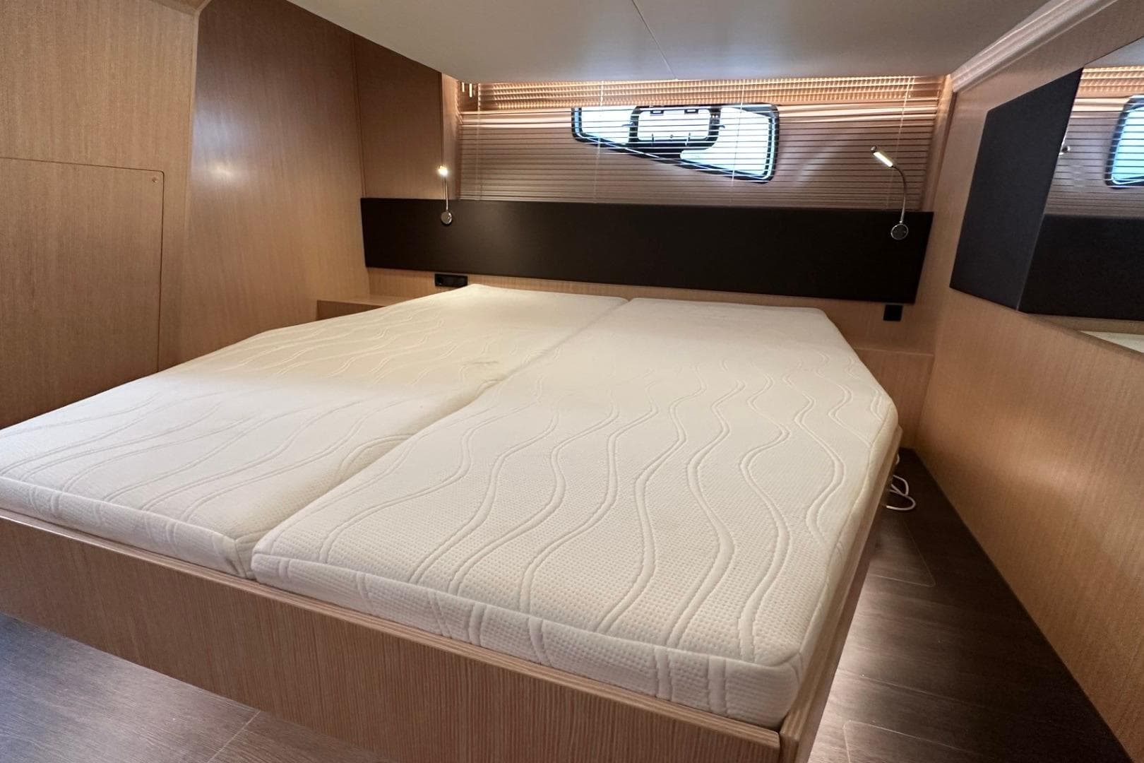 Luxurious cabin interior of 2023 Bavaria SR41 yacht with comfortable bedding.