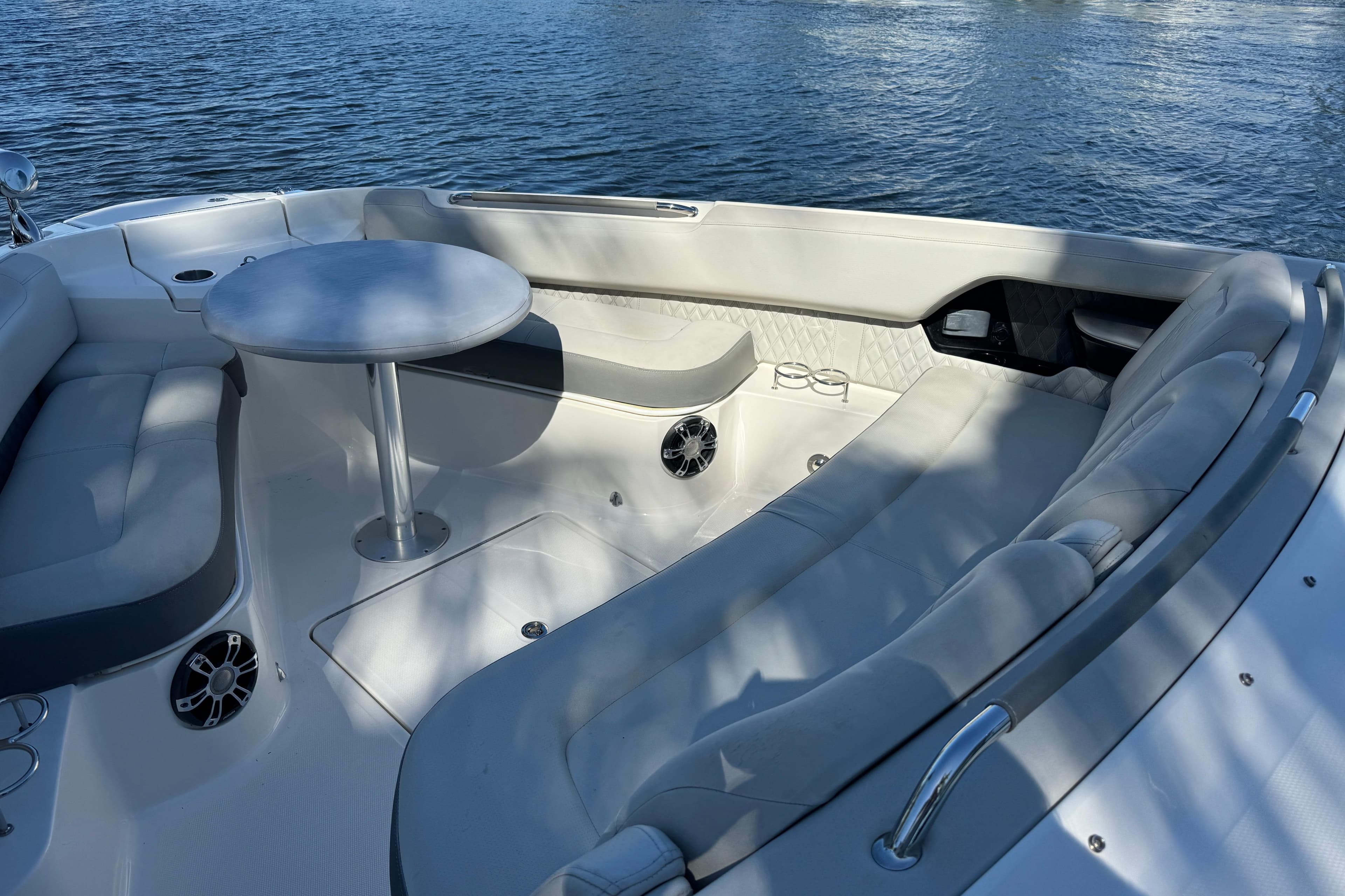 Luxurious seating area on 2022 Sea Ray SLX 400 Outboard boat, featuring a round table.