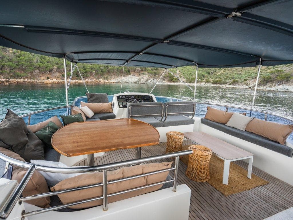 Luxurious 2008 Trader 64 Sunliner yacht with spacious outdoor seating and scenic water view.
