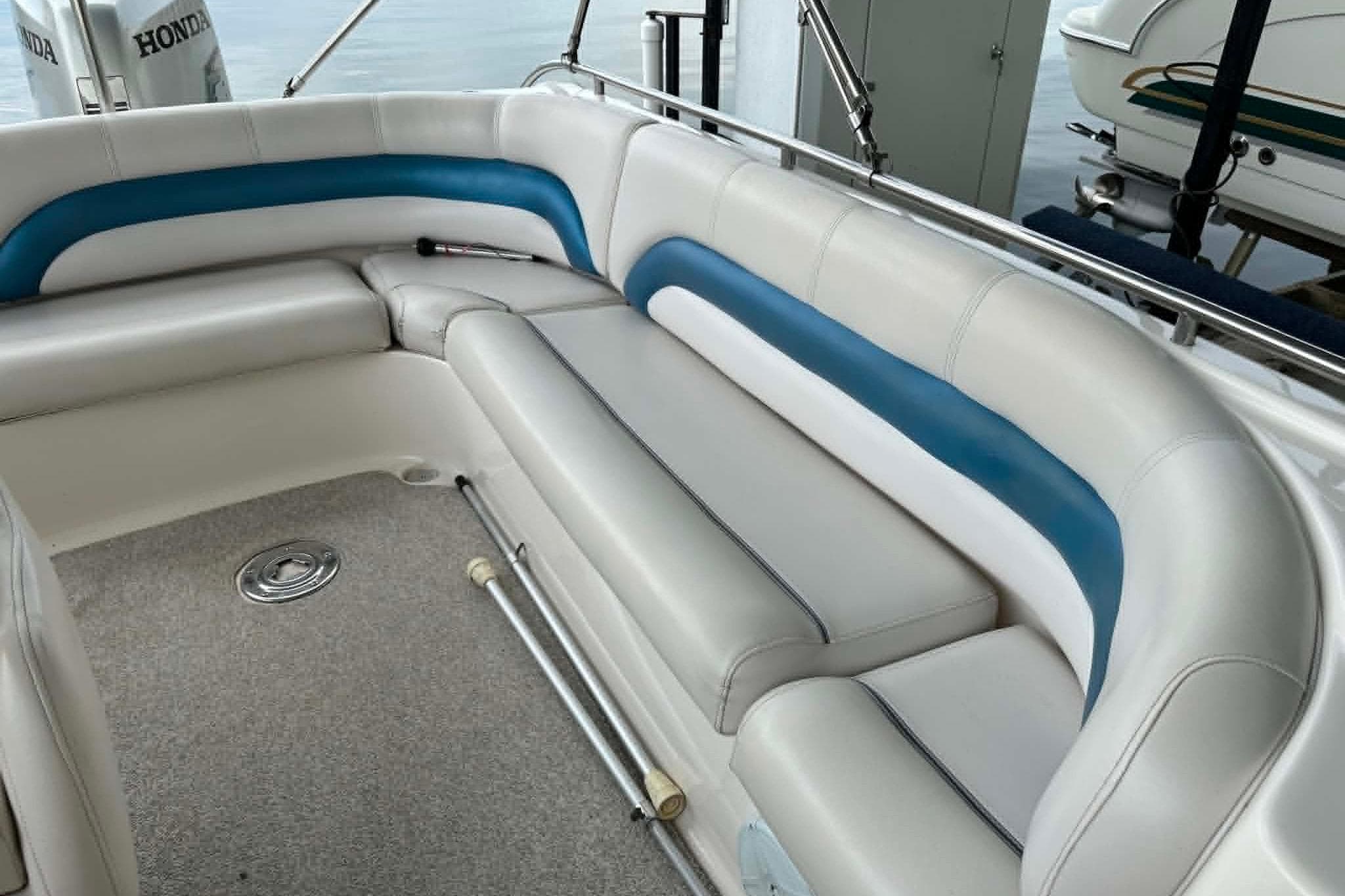 2006 Hurricane FunDeck GS 232 OB boat interior with white and blue seating.