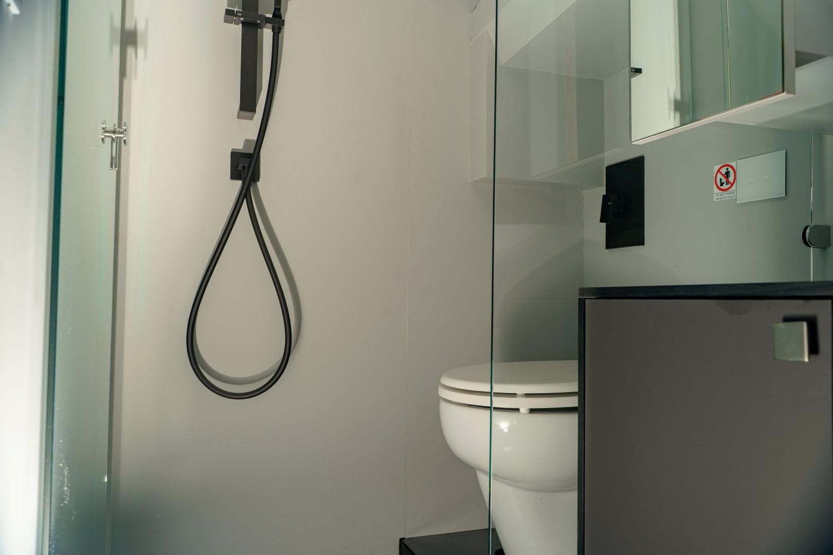 Modern bathroom in 2023 Anvera 48 yacht with sleek shower and toilet.