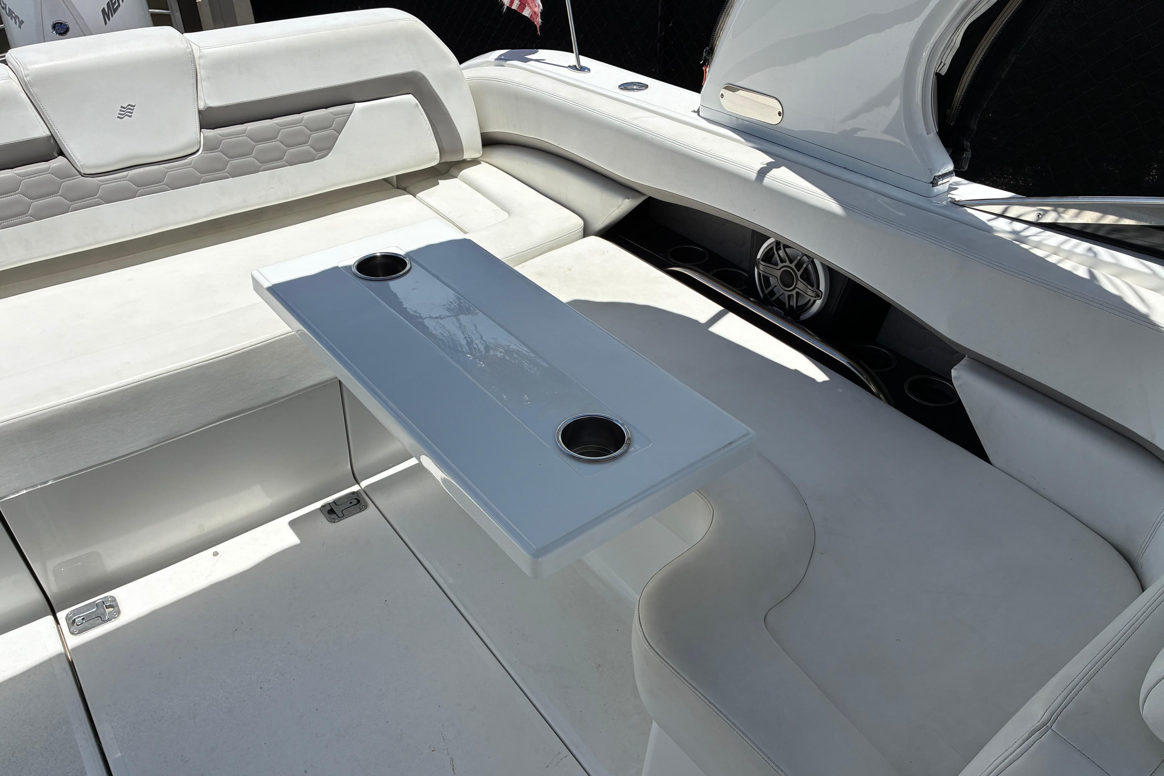 2020 Four Winns H290 OB boat interior with white seating and a sleek table.