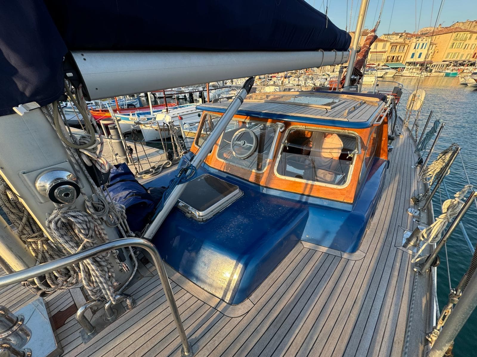 1974 Jongert 53 sailboat with wooden deck, docked in a marina under clear skies.