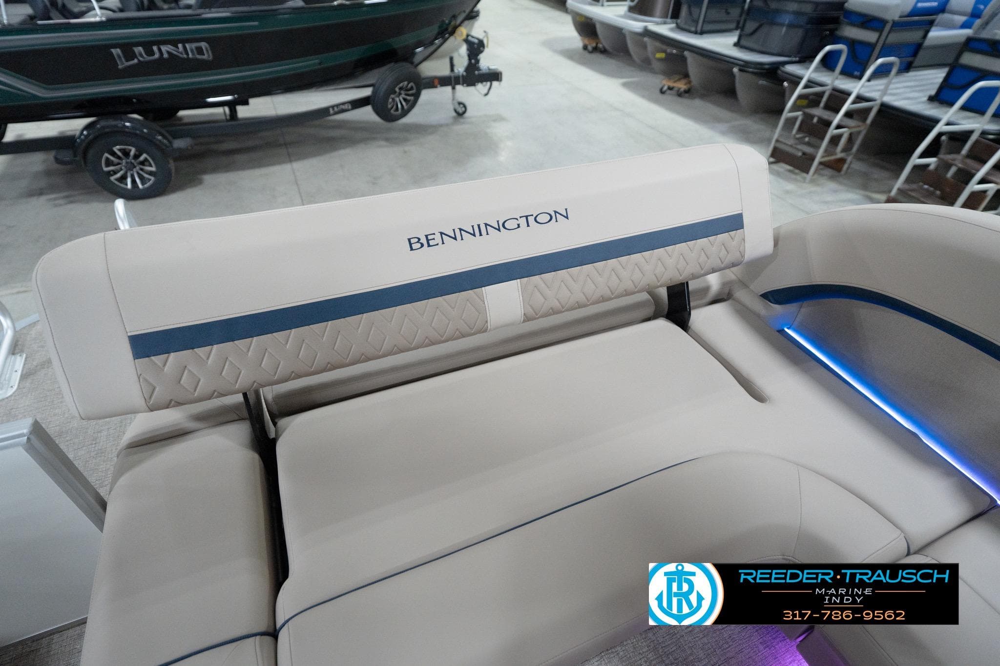 2026 Bennington 22 ML boat interior with beige seating and blue accents.